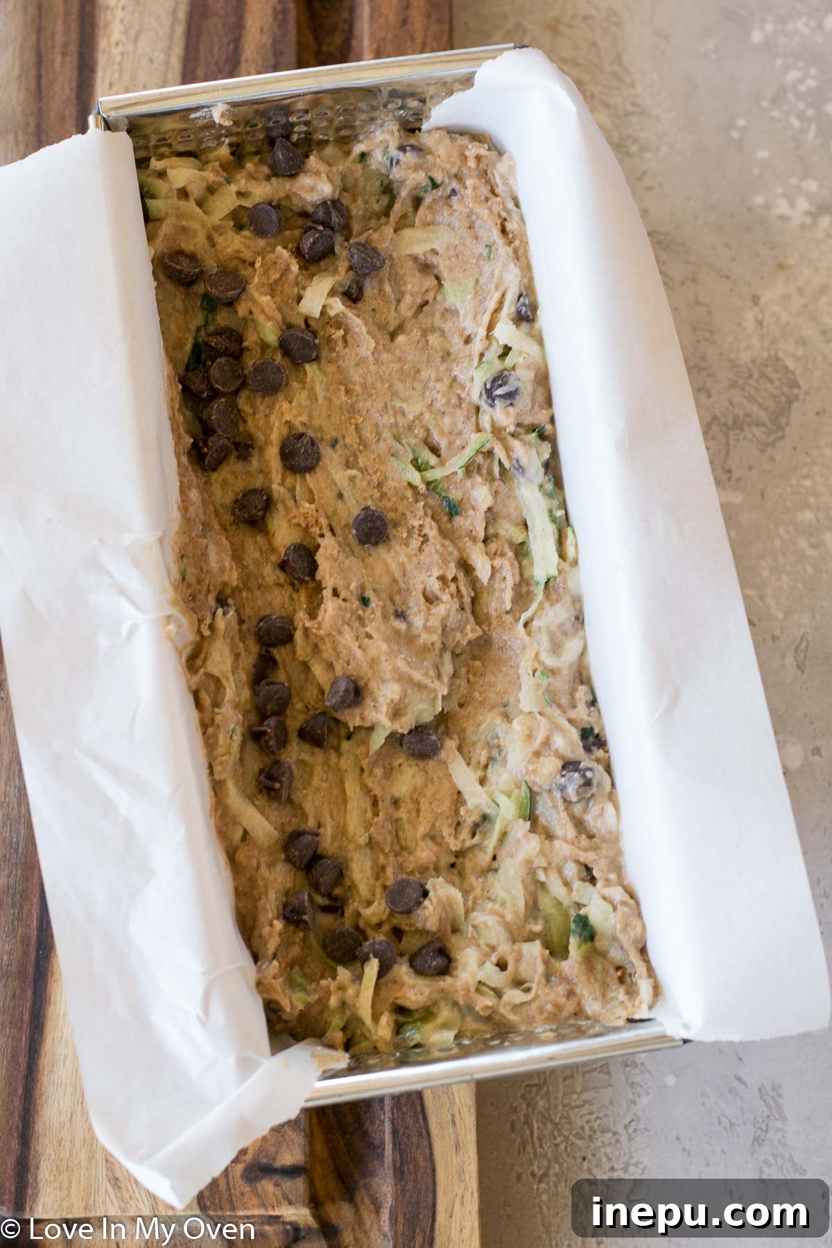 Zucchini bread batter with chocolate chips folded in, ready for the loaf pan