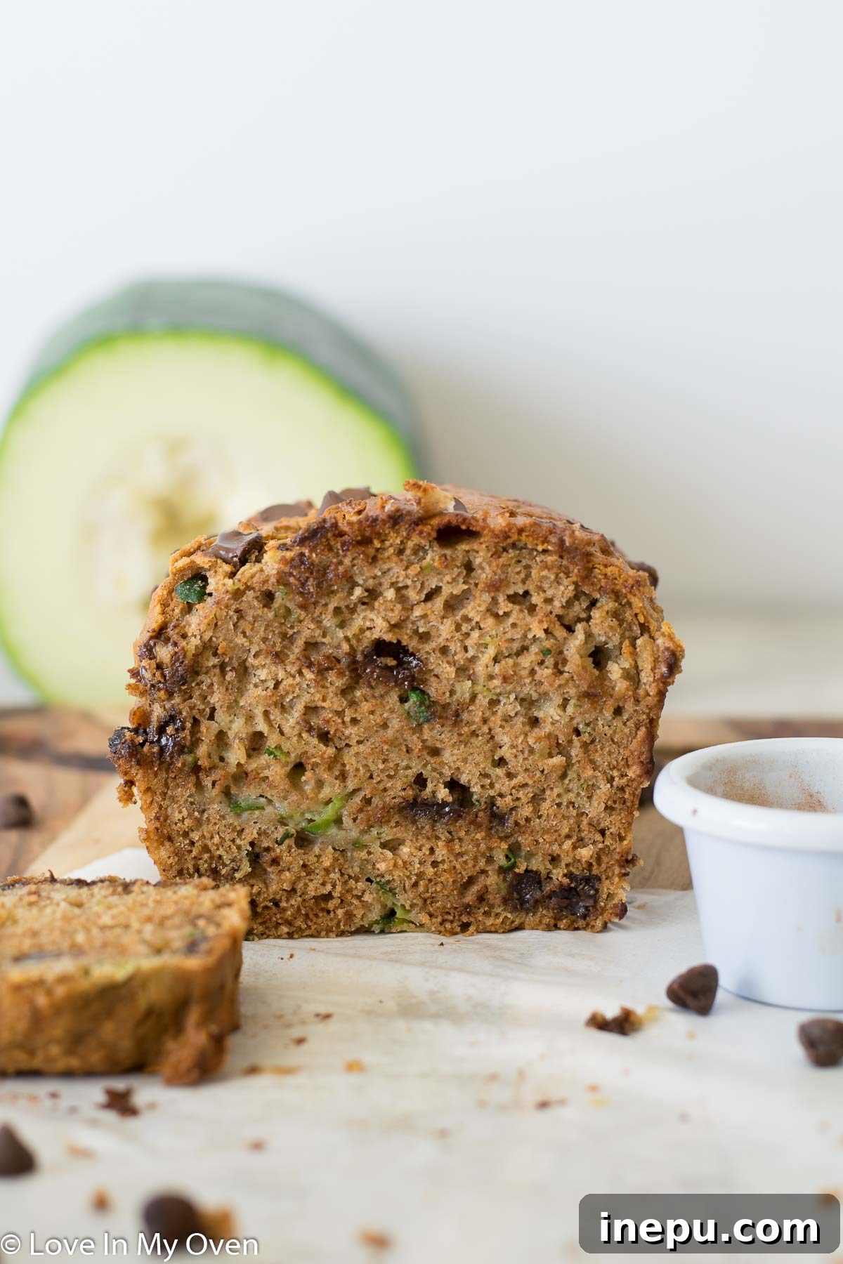 A freshly baked whole wheat zucchini bread loaf, sliced and stacked