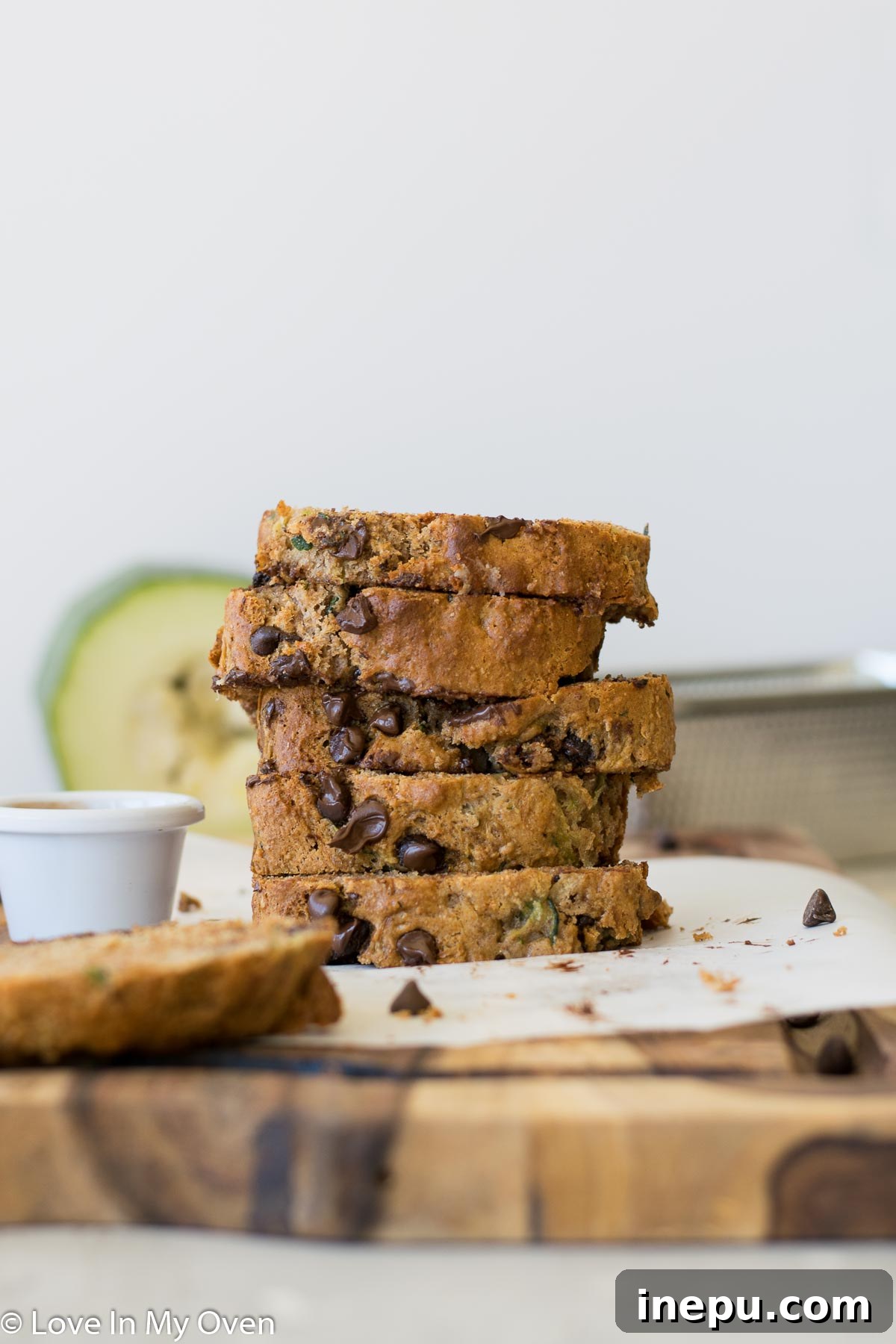 Close-up of a slice of whole wheat zucchini bread, highlighting its moist crumb and chocolate chips