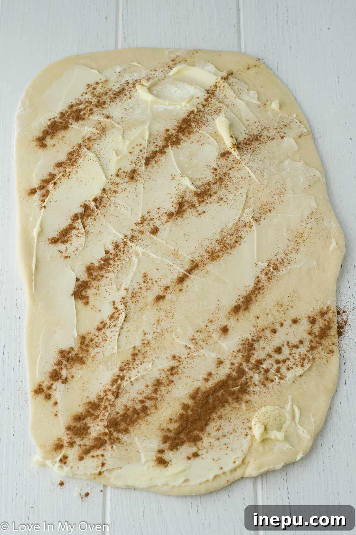 Golden Apple Cinnamon Tear-Apart Bake 7 Rolling dough and adding butter and cinnamon