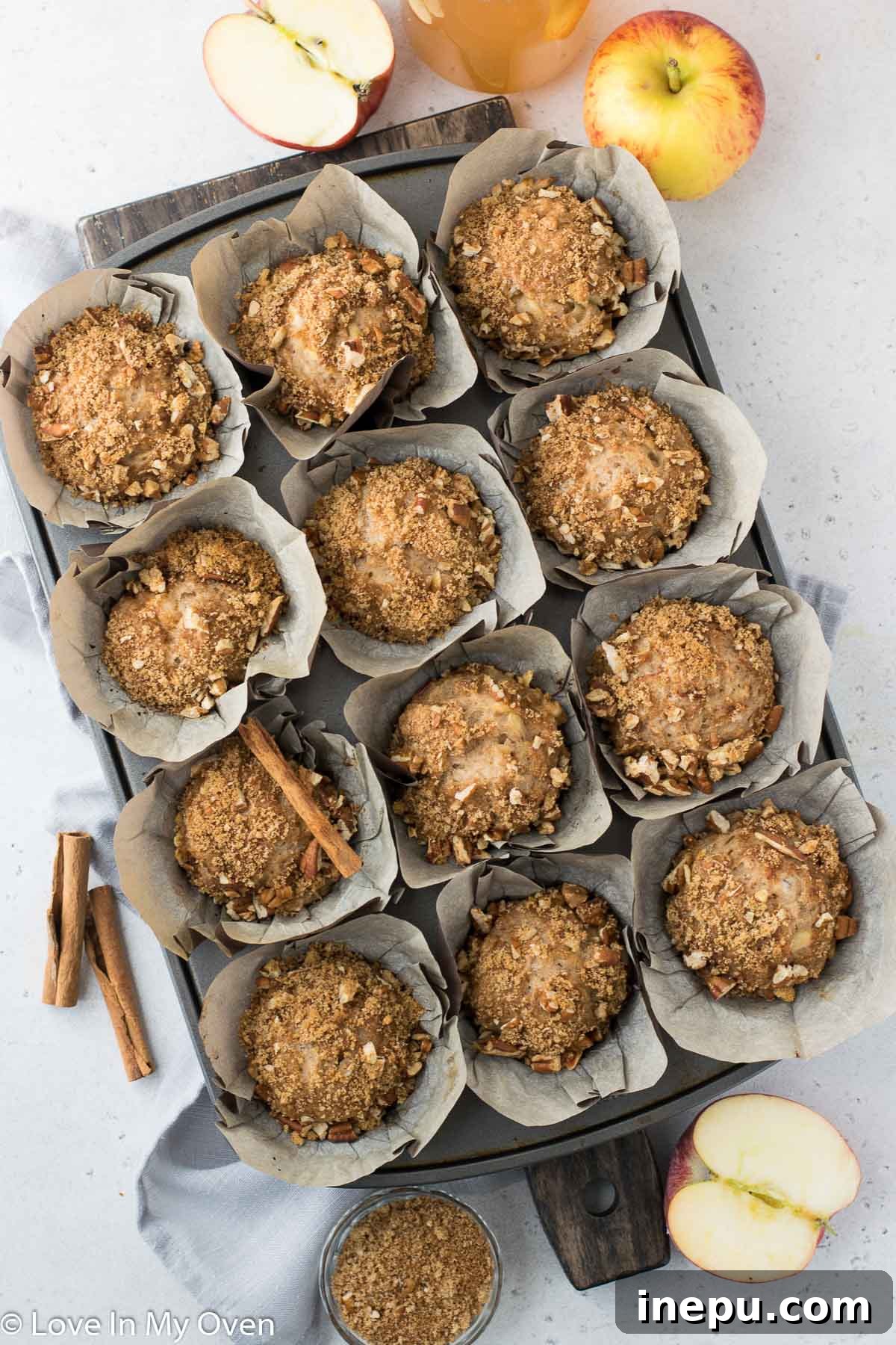 Harvest Spiced Cider Muffins 7 Freshly baked apple cider muffins cooling on a wire rack.