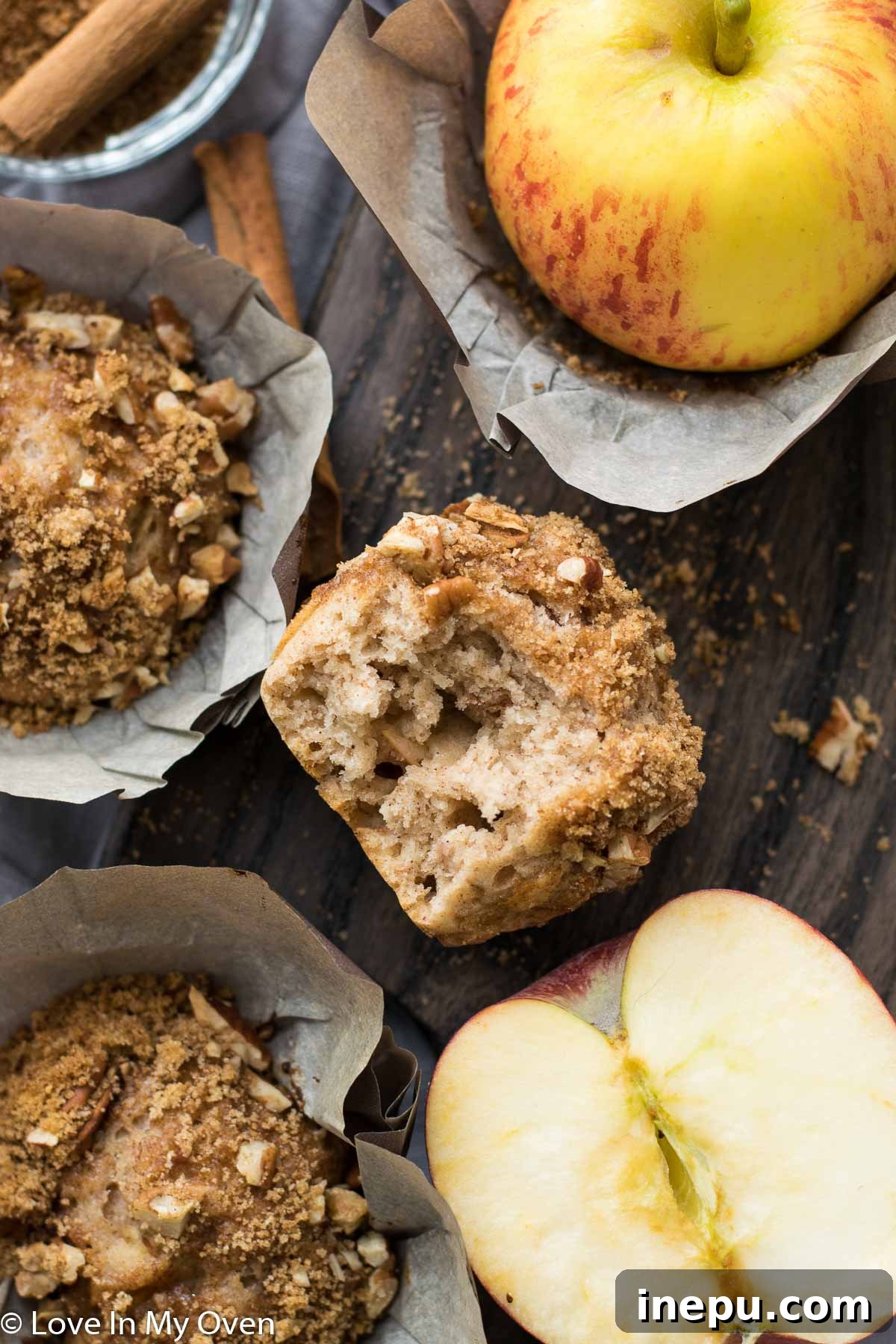 Harvest Spiced Cider Muffins 8 Two hands holding a warm apple cider muffin, showing its moist interior and crumble.