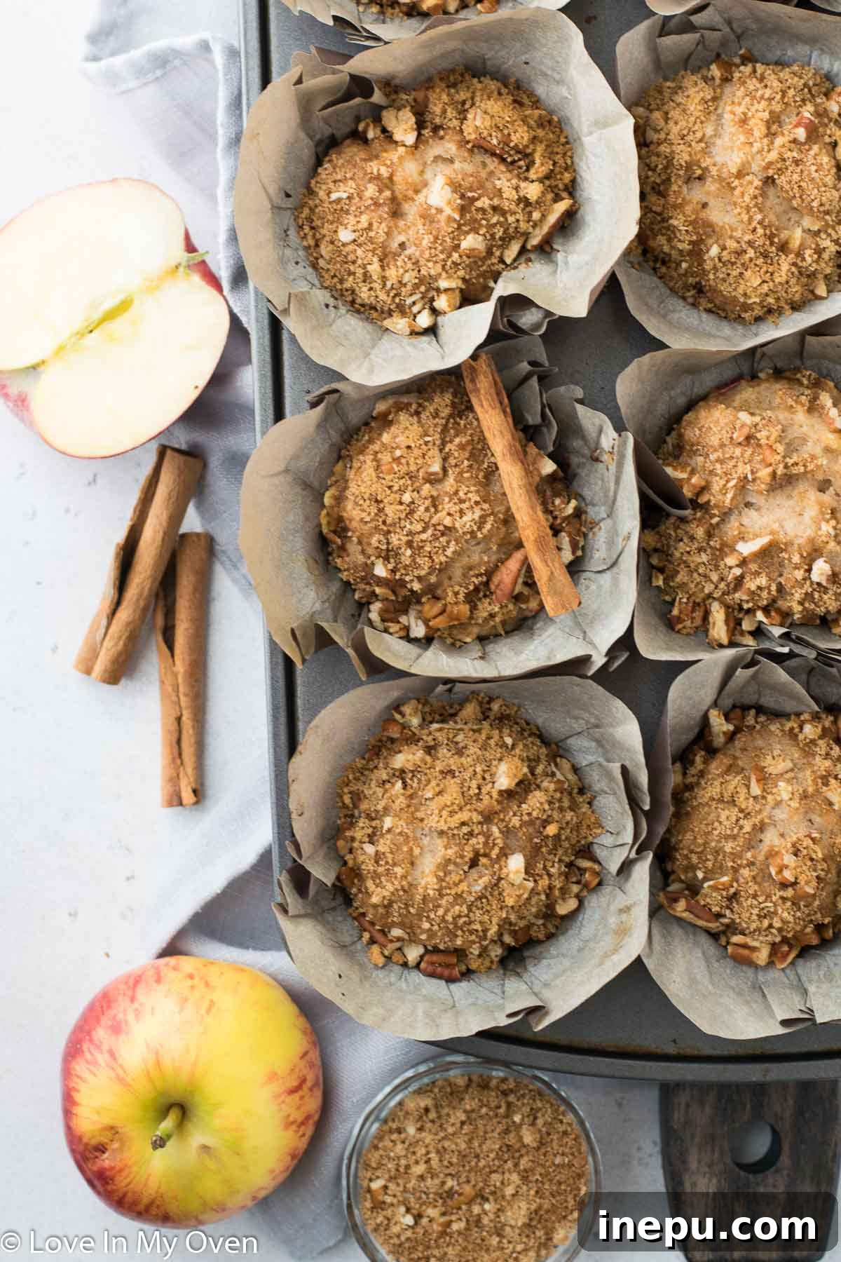 Harvest Spiced Cider Muffins 9 A basket filled with warm apple cider muffins, ready to be served.