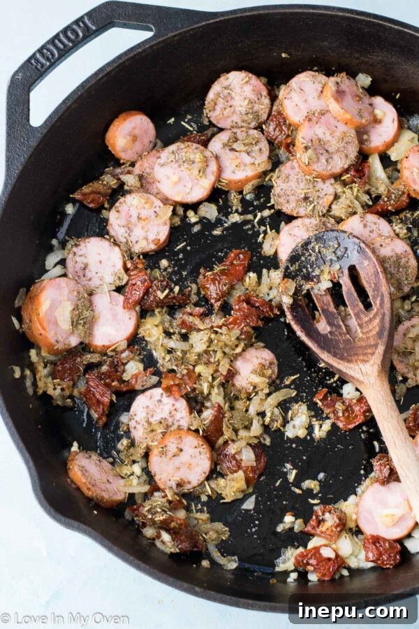 Hearty Shrimp and Sausage Pasta 5 Dry fettuccine pasta being added to the one-pot dish