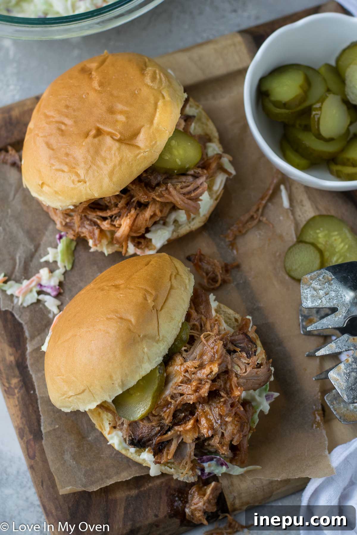 Apple Infused Pulled Pork 7 apple cider pulled pork on a bun with pickles and coleslaw