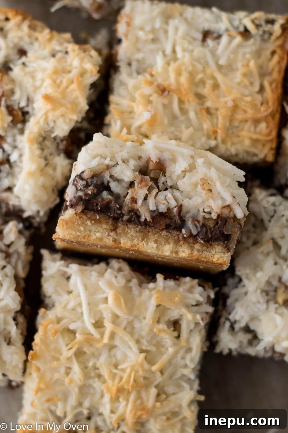 Plant-Based Dream Bars 3 Close-up of baked vegan magic bars in a pan, showcasing their layers.