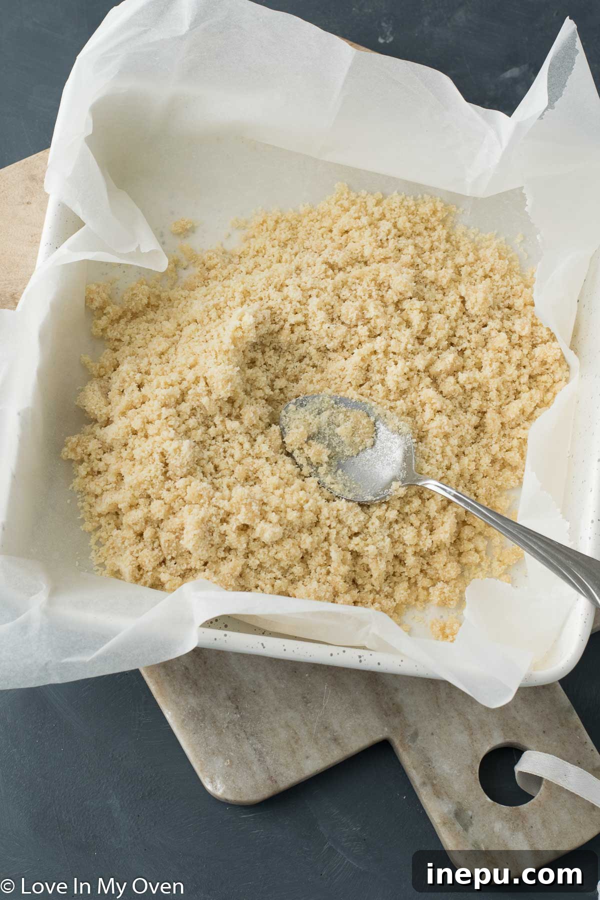 Plant-Based Dream Bars 4 Mixing almond flour, maple syrup, and coconut oil for the crust of vegan magic bars.