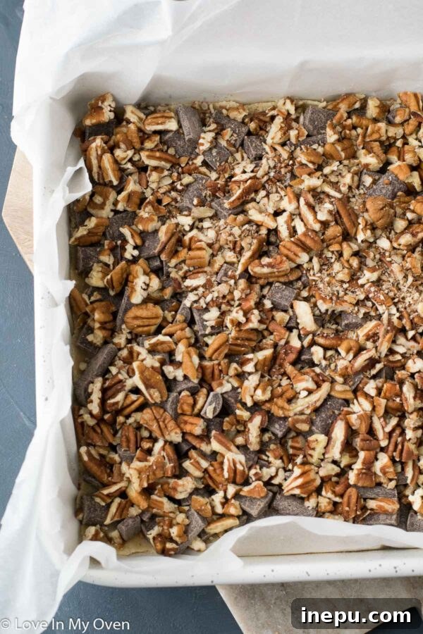 Plant-Based Dream Bars 6 Layer of chopped pecans spread over chocolate chips for vegan magic bars.