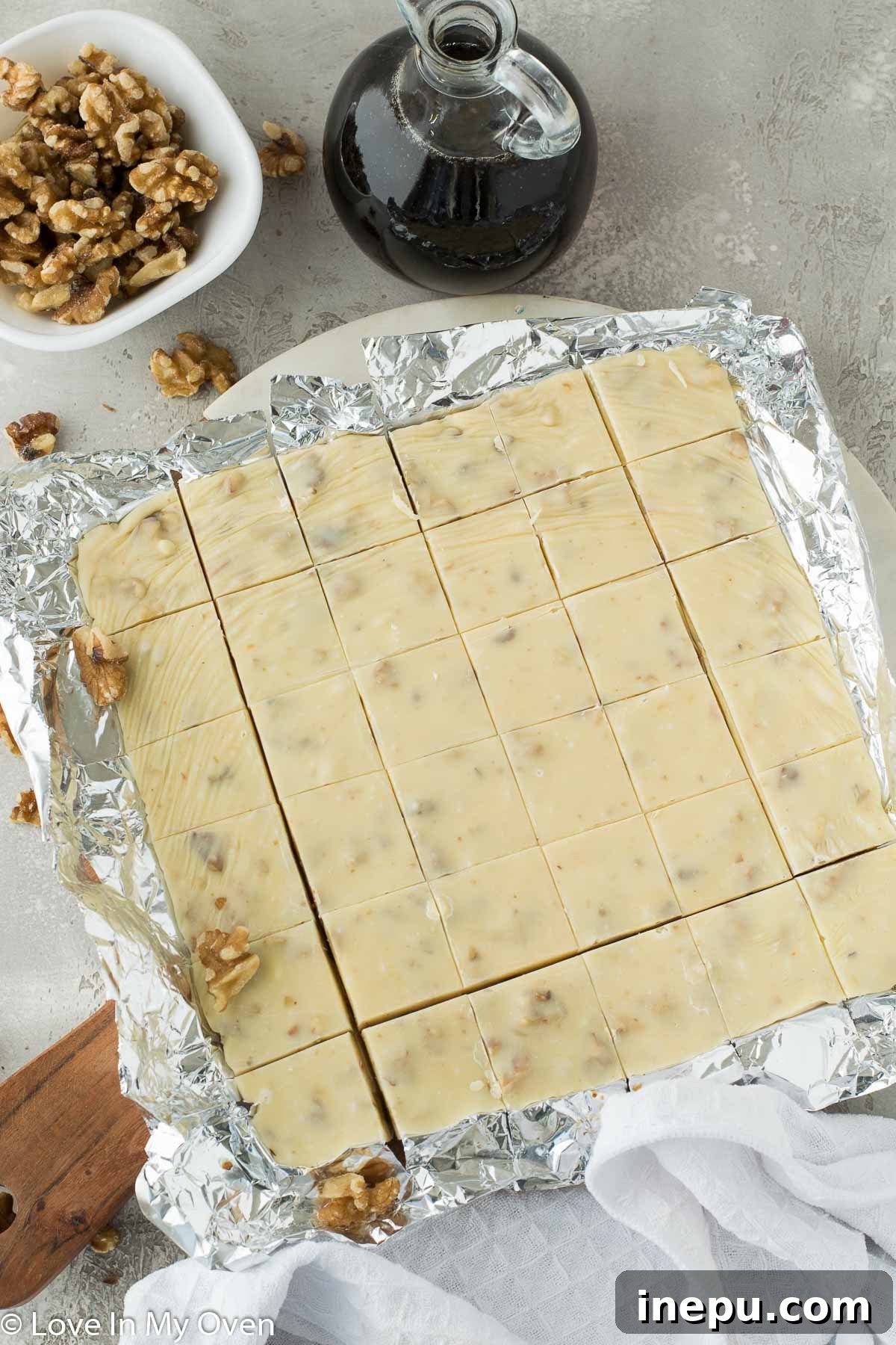 Maple walnut fudge cut into perfect squares on a cutting board, ready to serve.