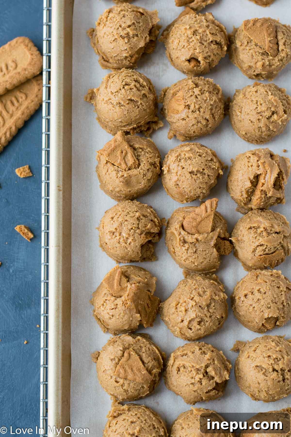 Raw cookie dough balls on a baking sheet