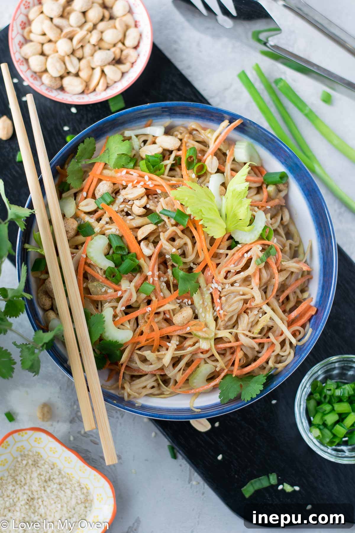 A large bowl of sesame peanut noodle salad ready for serving