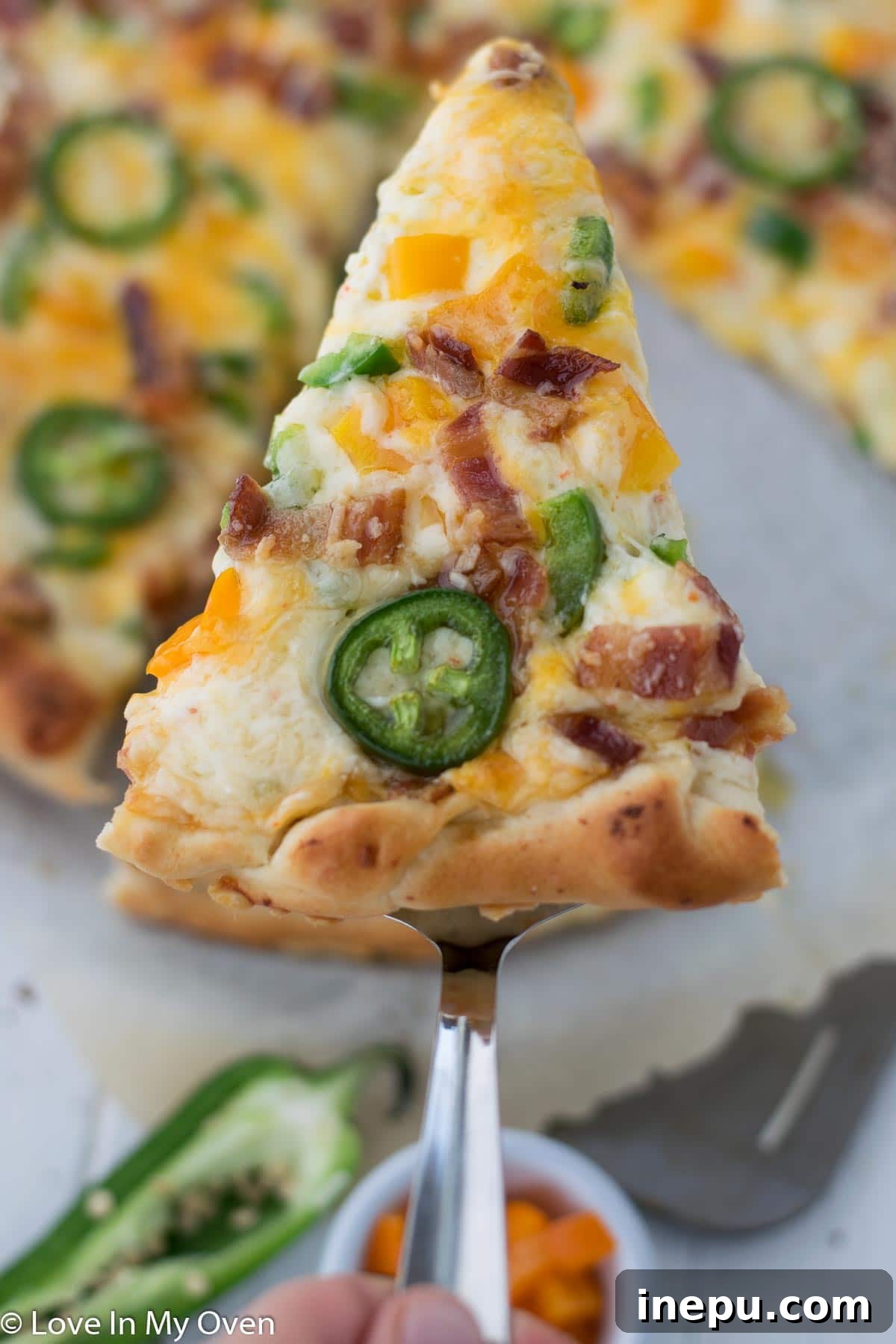 A top-down shot of the bubbly, golden Jalapeño Popper Pizza