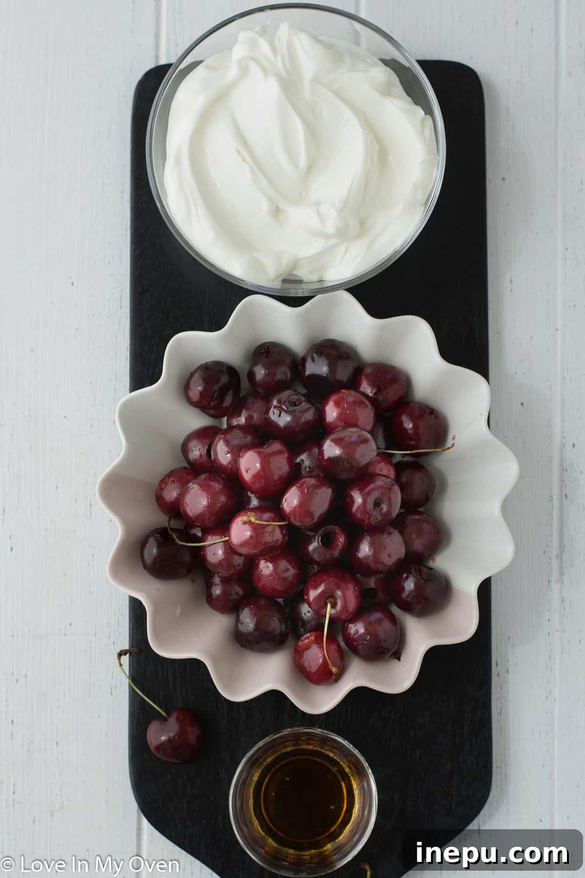 Close-up of fresh cherries and Greek yogurt, key ingredients for homemade popsicles.