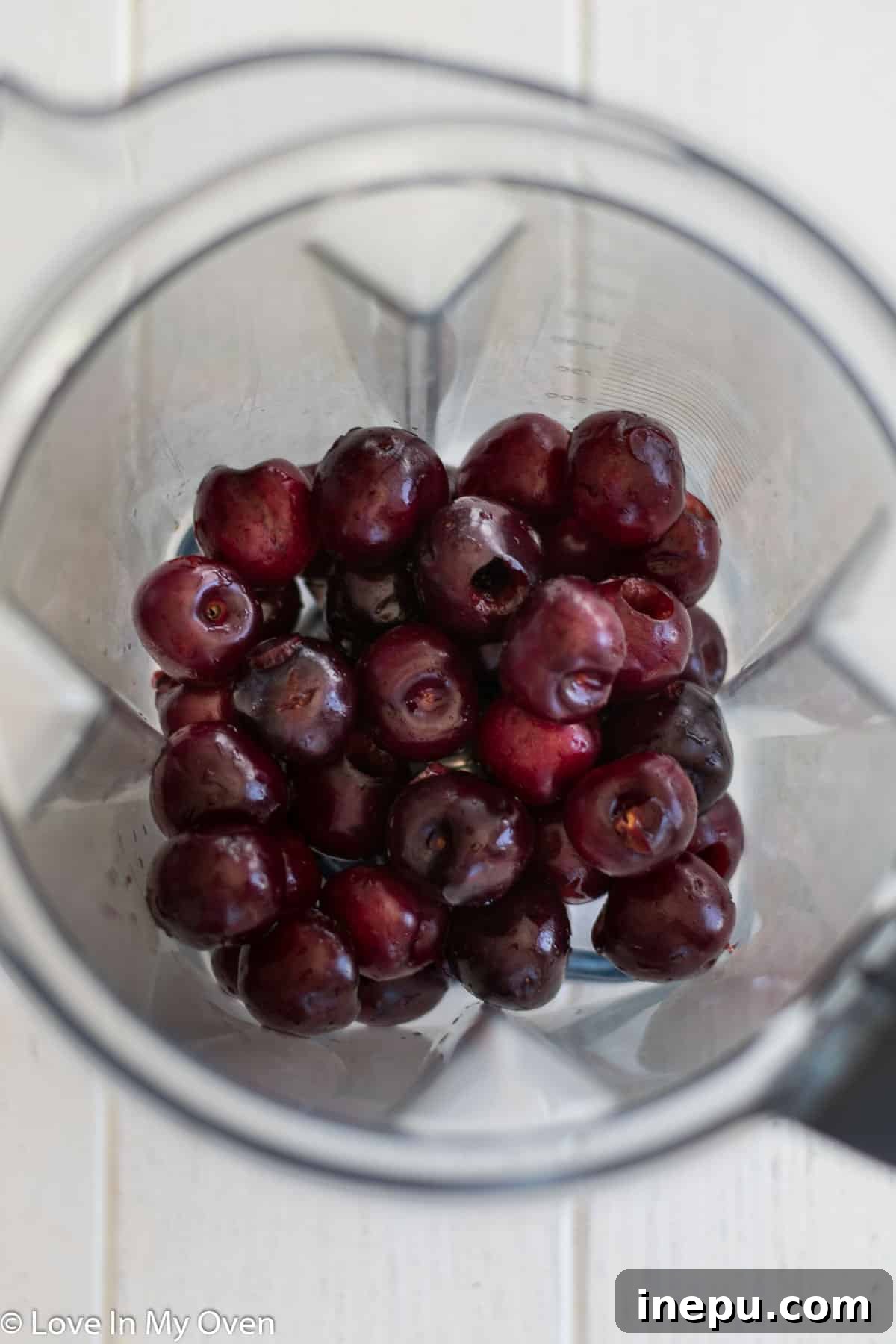 Blending fresh cherries with maple syrup for popsicle base.