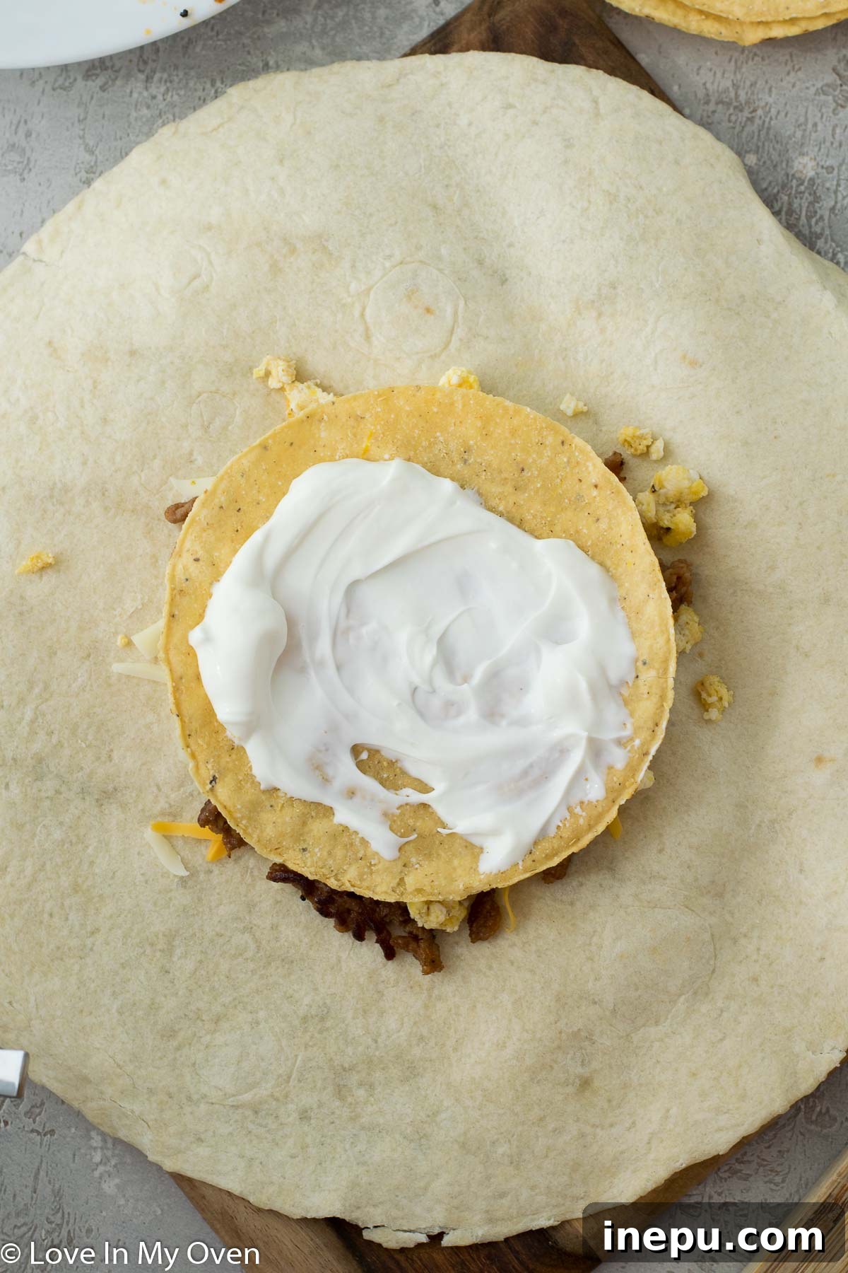Sunrise Crunchwrap 6 Adding sour cream and salsa to breakfast crunch wrap