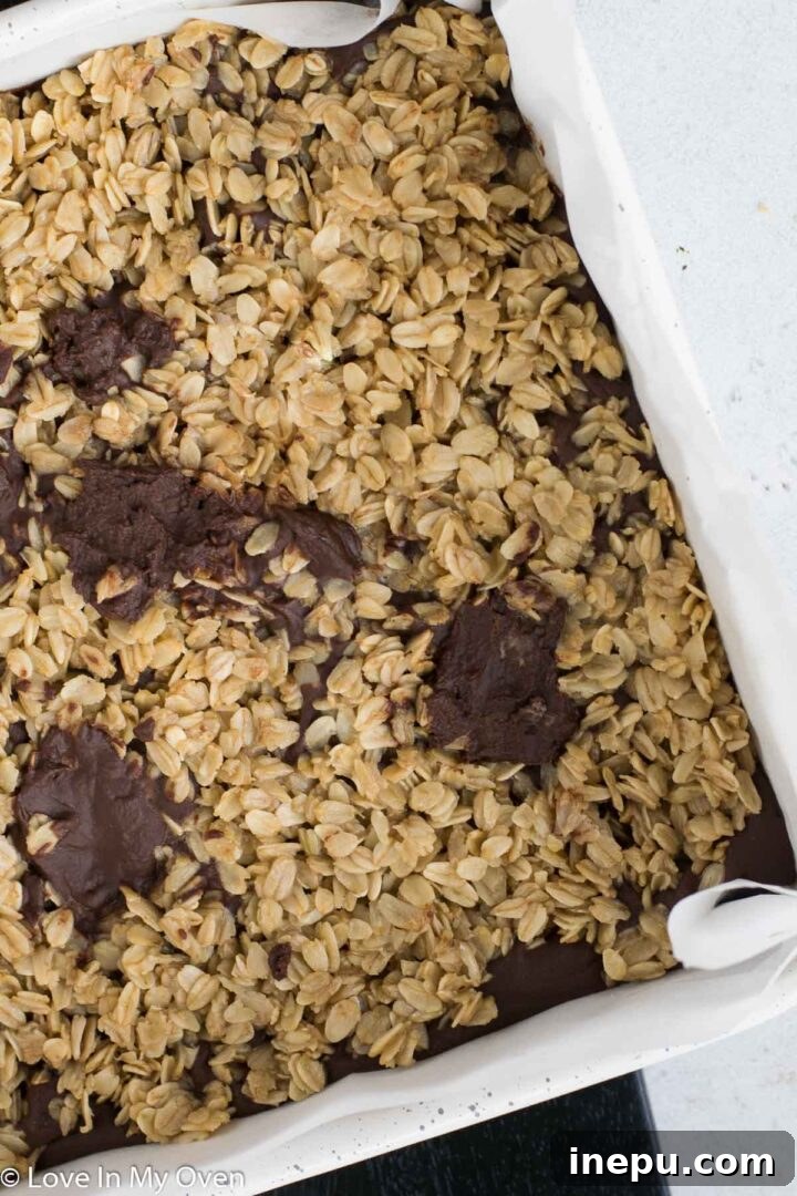 Close-up of a single gluten free oatmeal fudge bar, showing the distinct layers