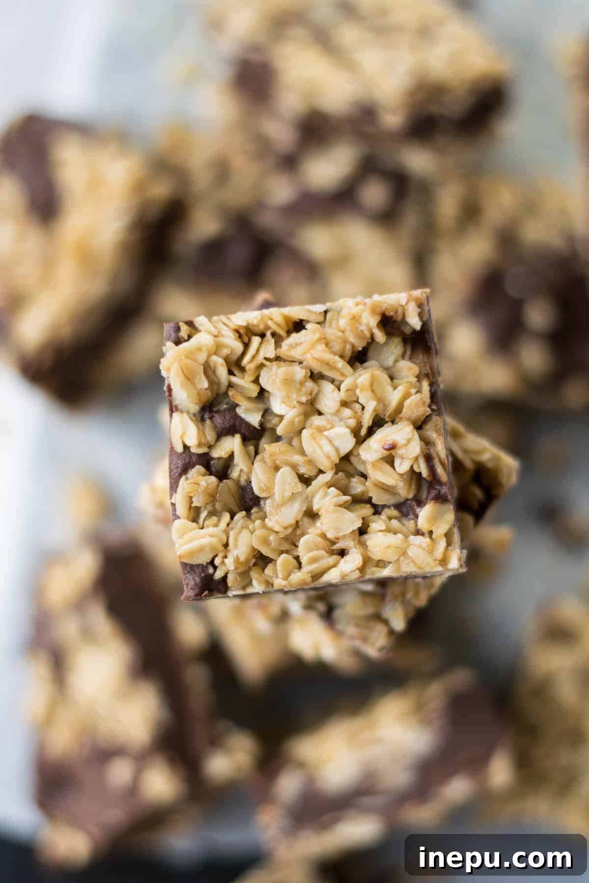 Stacked oatmeal fudge bars with chocolate fudge peeking through