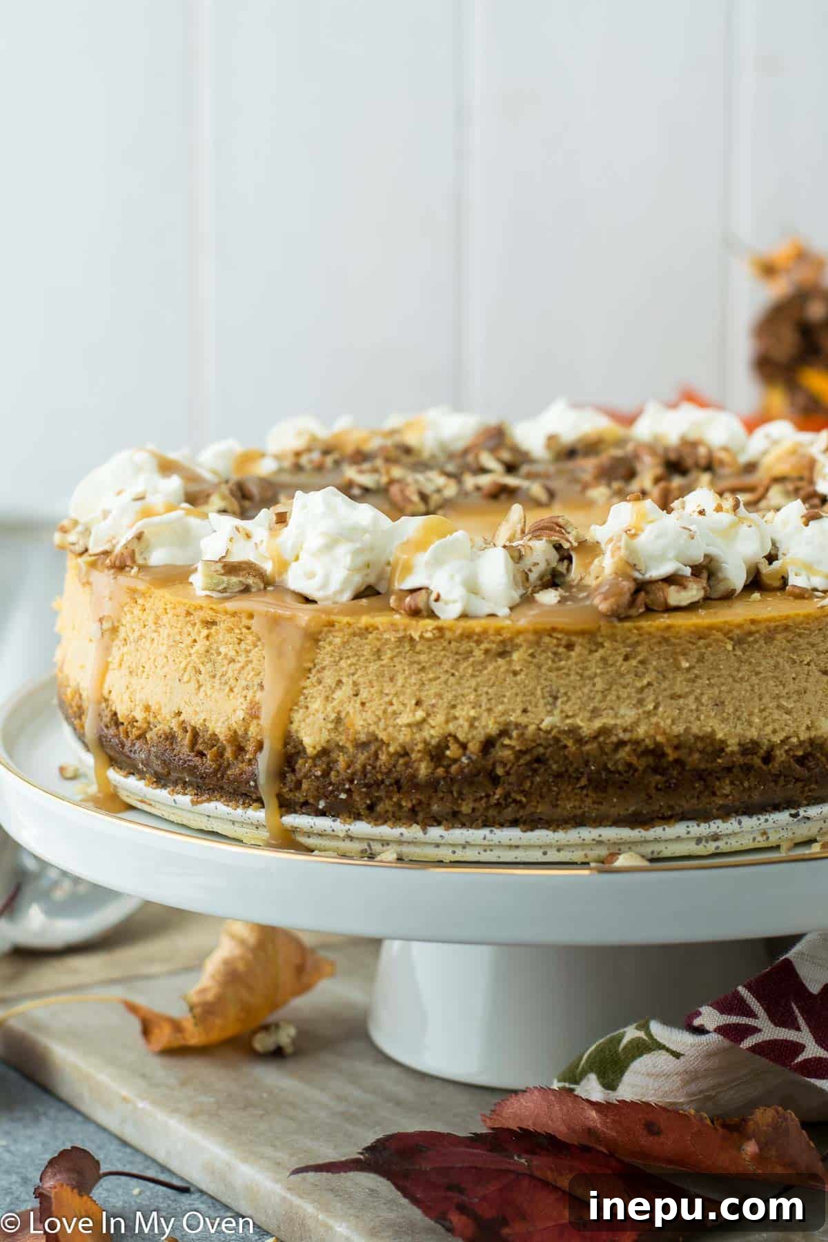 Pumpkin Caramel Cheesecake 2 Caramel Pumpkin Cheesecake ready for serving, showcasing its golden-brown crust and smooth, creamy filling topped with caramel drizzle.