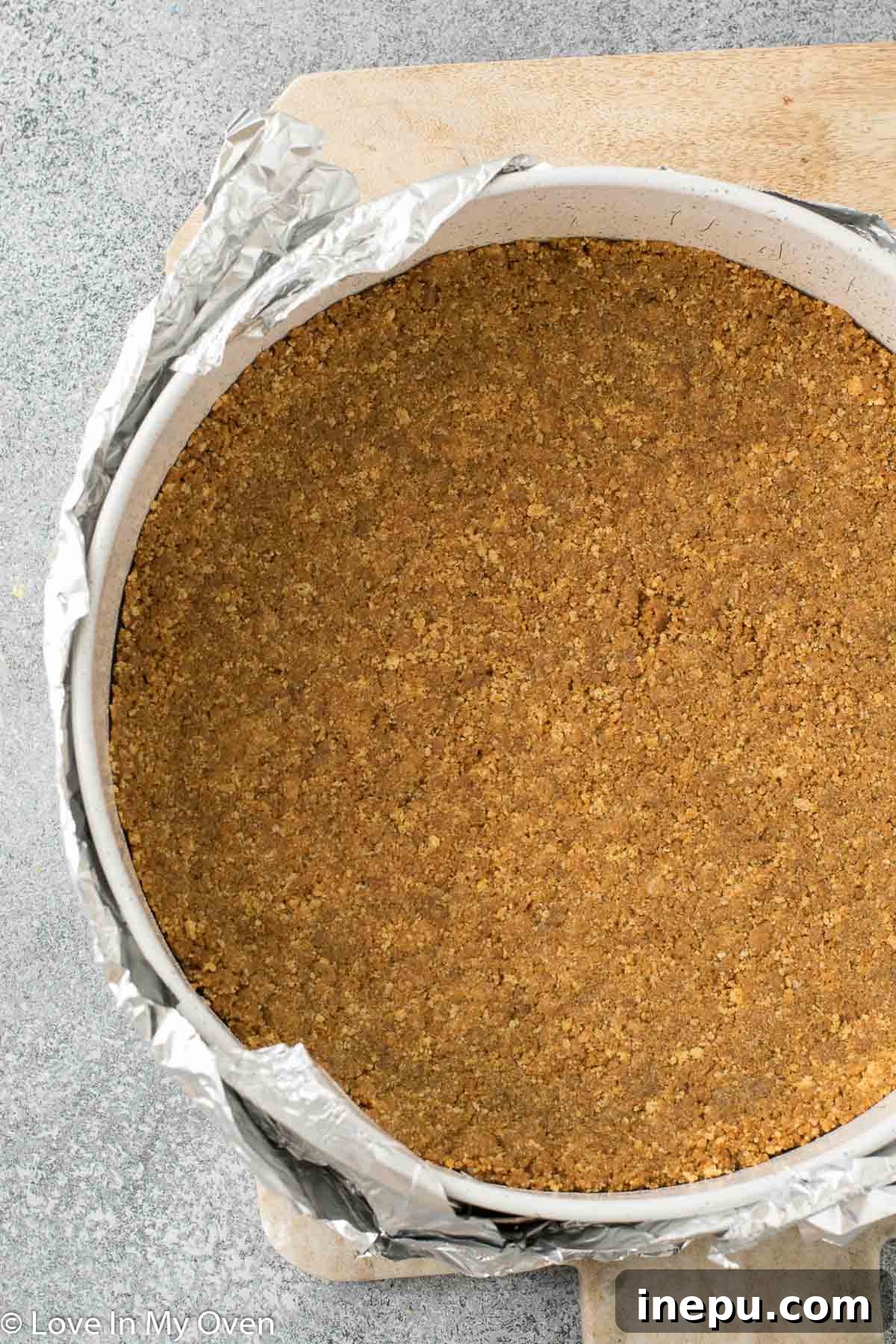 Pumpkin Caramel Cheesecake 3 Gingersnap crust pressed into a springform pan, ready for baking.