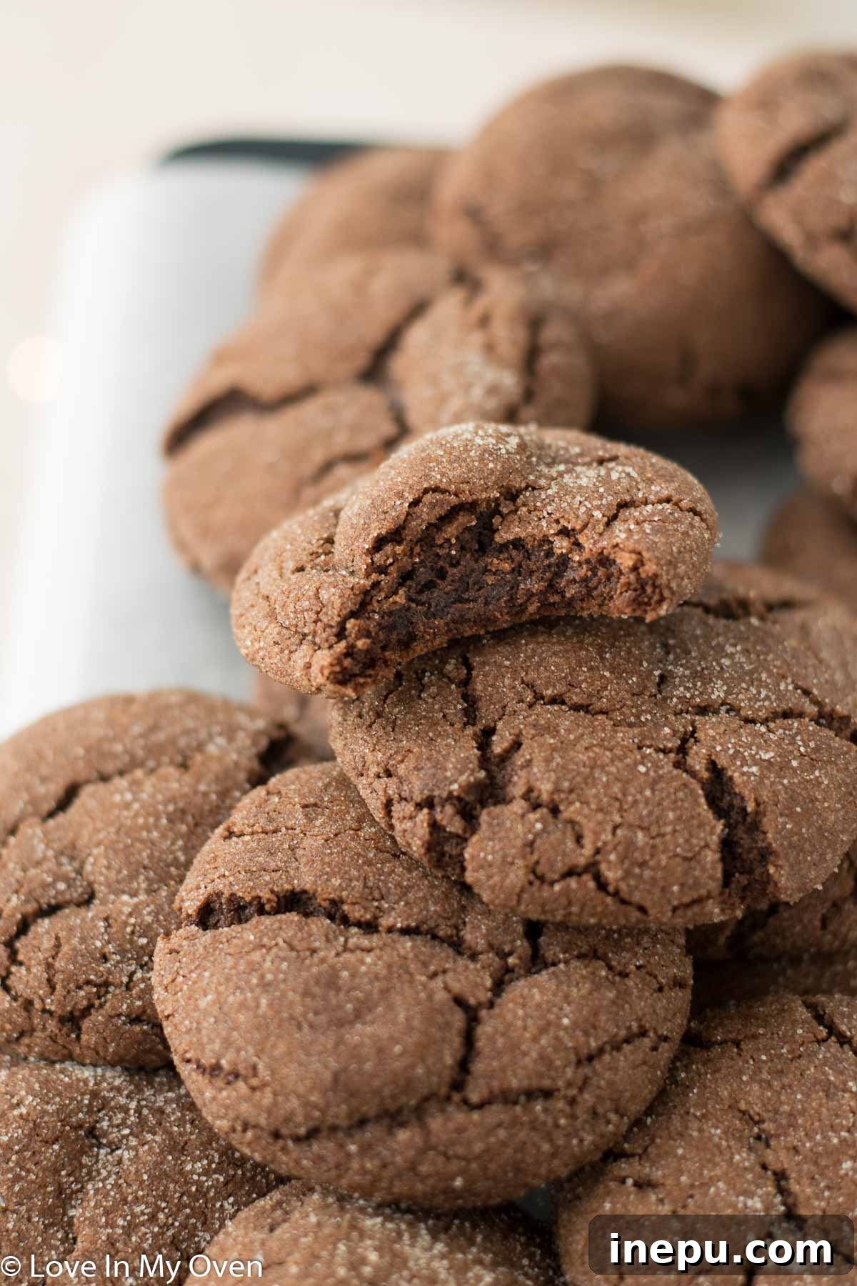 Double Chocolate Snickerdoodles 2 Thick, chewy chocolate snickerdoodles coated in cinnamon sugar, cooling on a rack