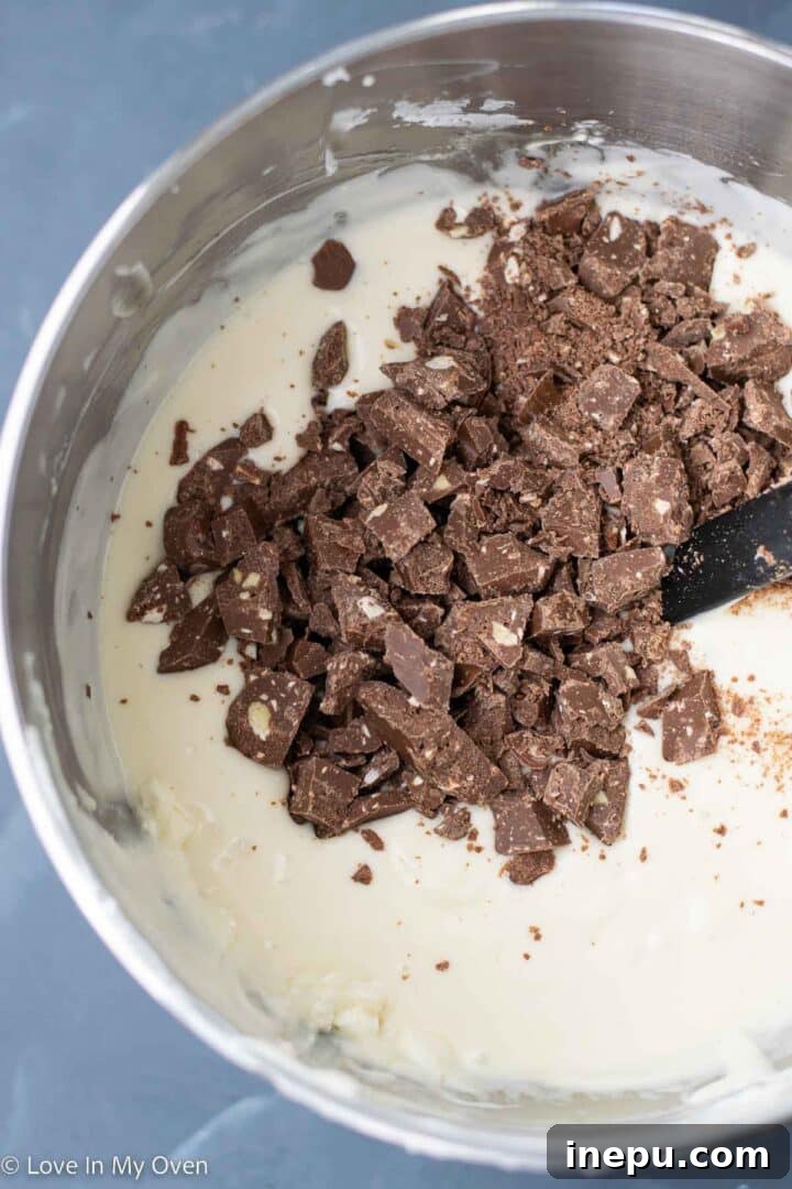 Decadent Toblerone Cheesecake 6 Pouring Toblerone cheesecake batter into a springform pan.