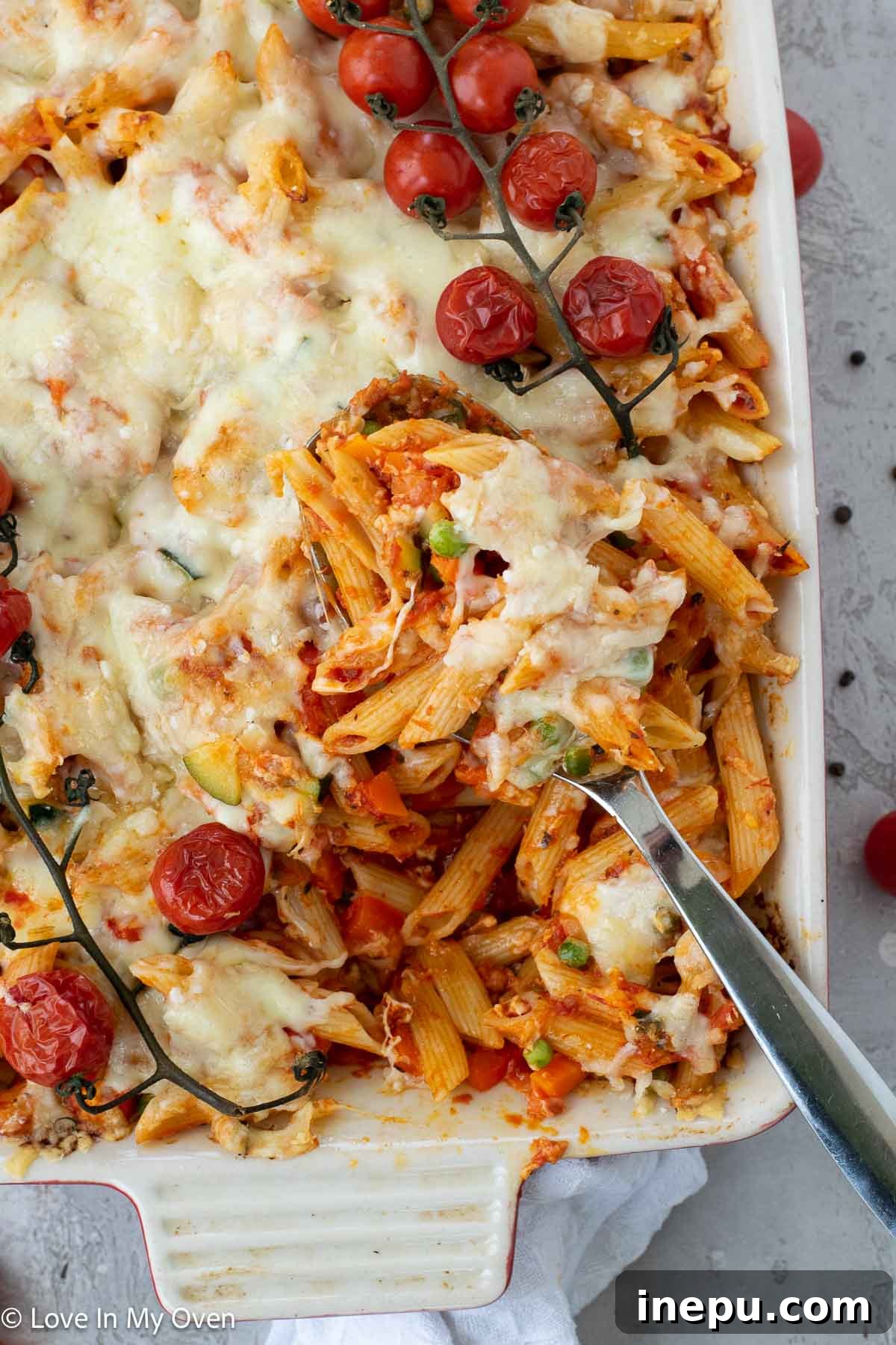 Cheesy Baked Veggie Pasta 8 The full cheesy veggie pasta bake in its casserole dish, with a serving spoon, ready for the table
