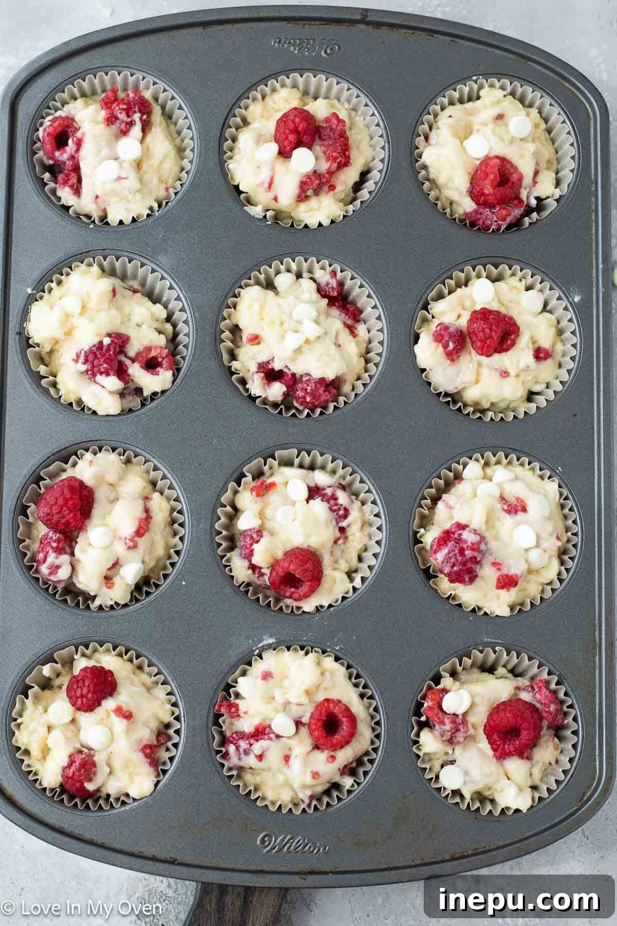 Luscious Raspberry White Chocolate Muffins 5 Muffins baking in the oven, showing a beautiful golden-brown top