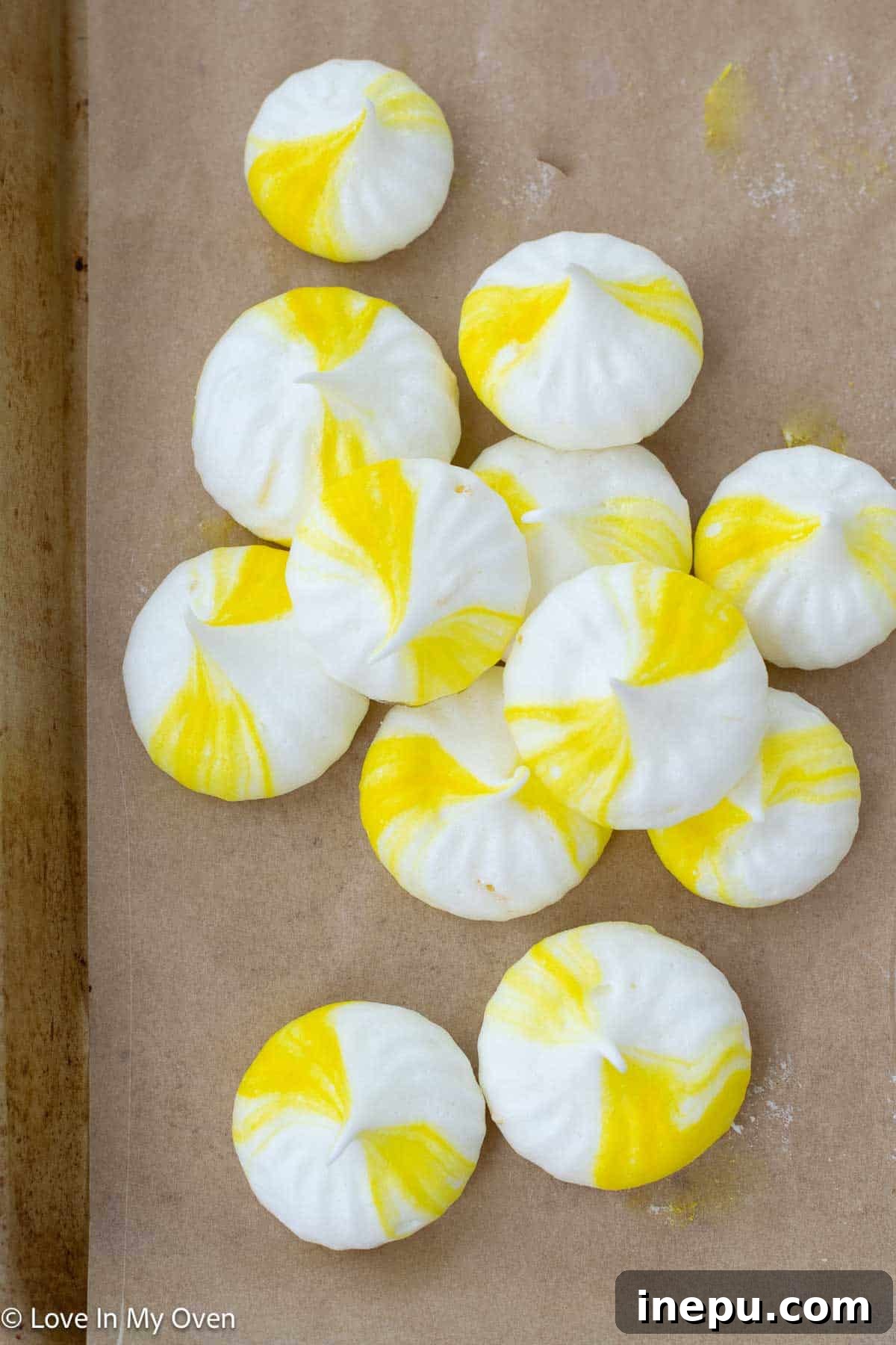 Finished lemon meringue cookies with a golden-yellow swirl, displayed beautifully.