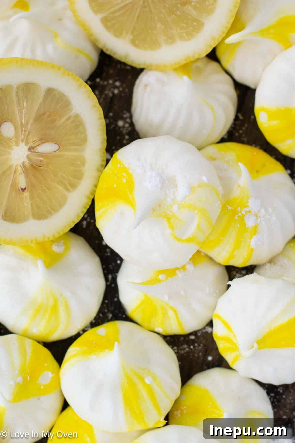 Lemon meringue cookies arranged artfully on a white plate, showcasing their light texture.