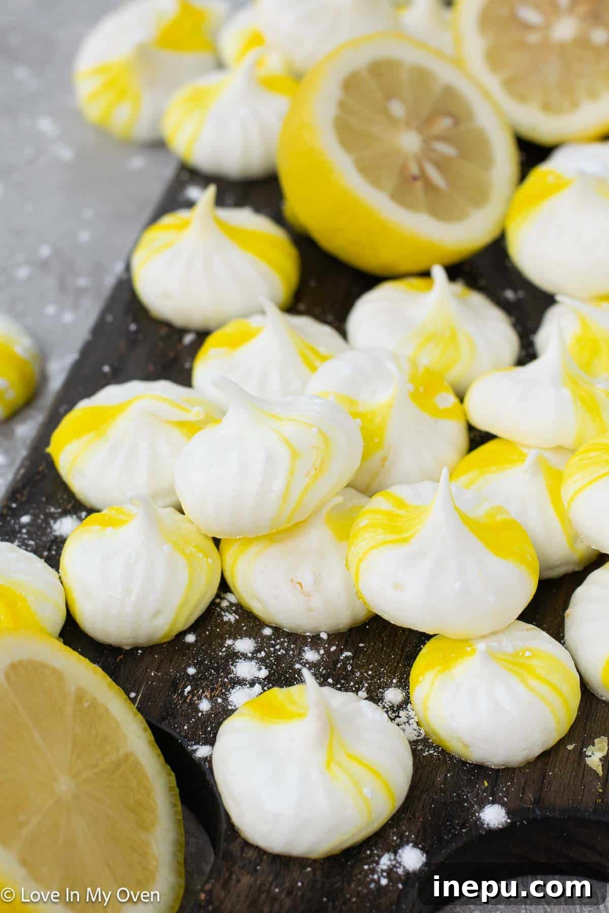 A close-up of a single perfectly baked lemon meringue cookie, highlighting its crisp texture.