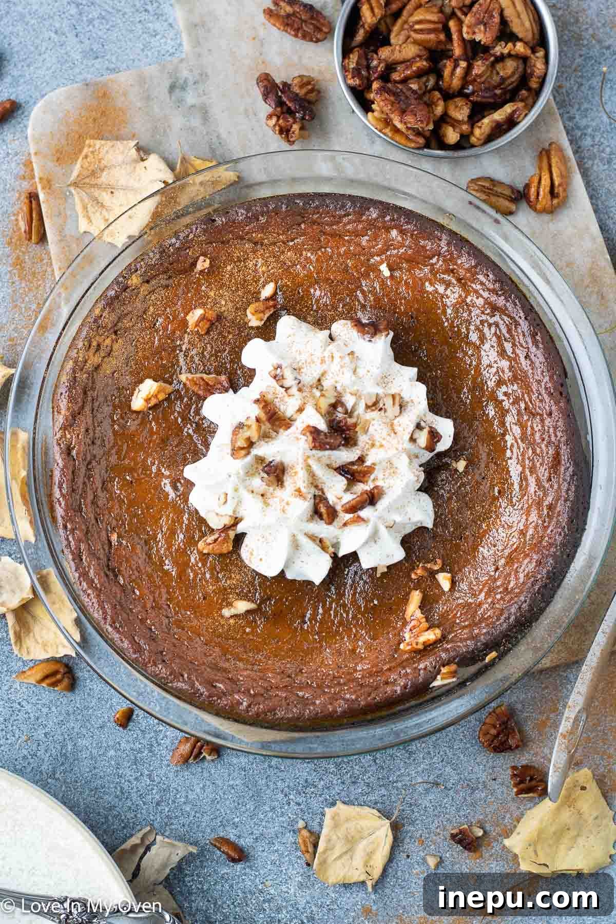 Silky Pumpkin Custard 2 Classic crustless pumpkin pie garnished with whipped cream on a festive table