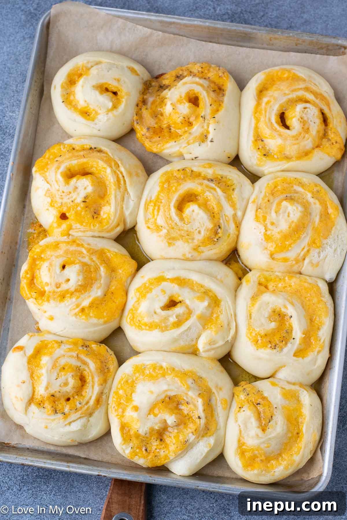 close-up of baked golden brown cheese rolls on a cooling rack