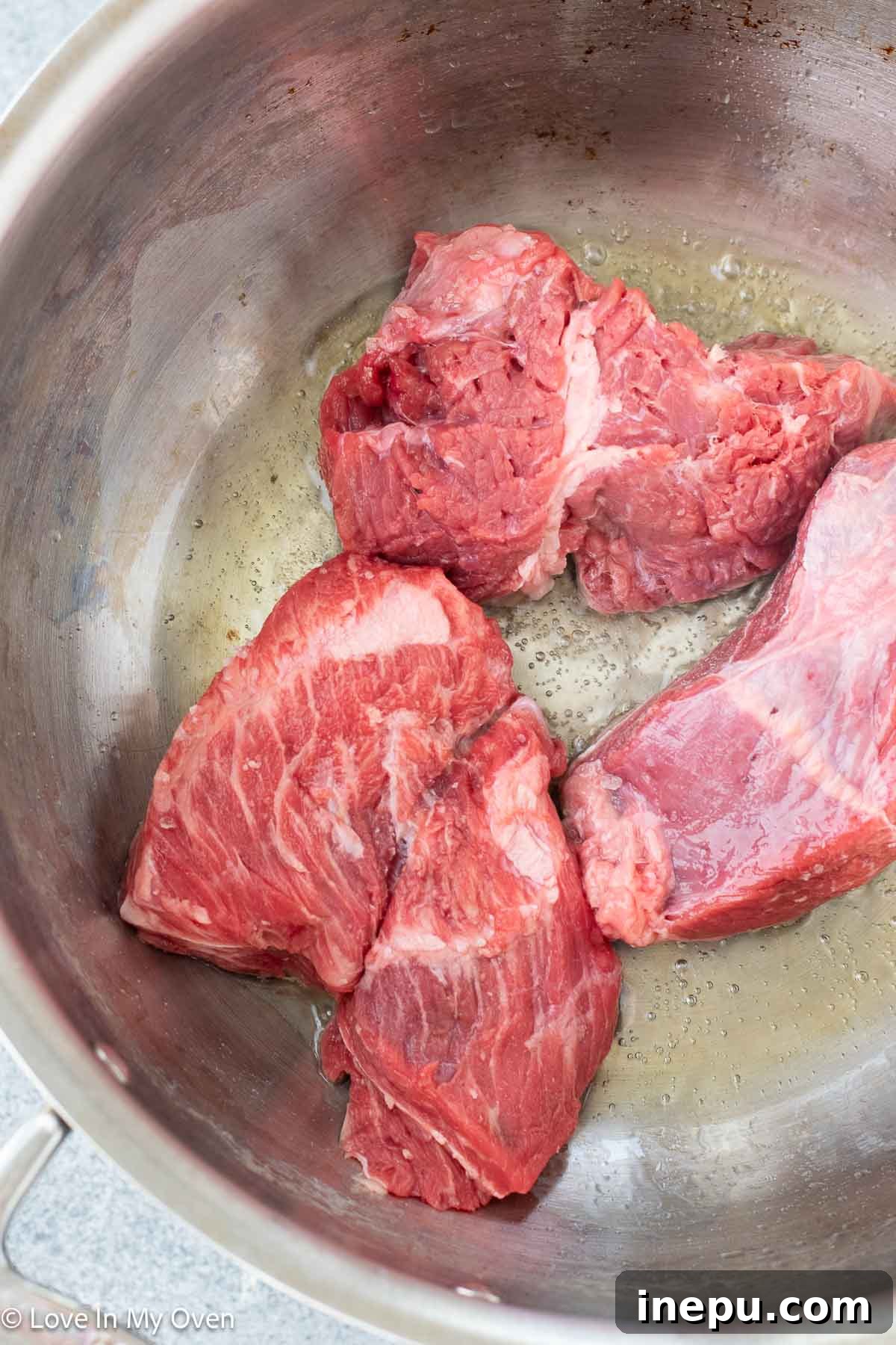 Massaman Beef Curry 5 Close up of seared beef chunks in the Dutch oven