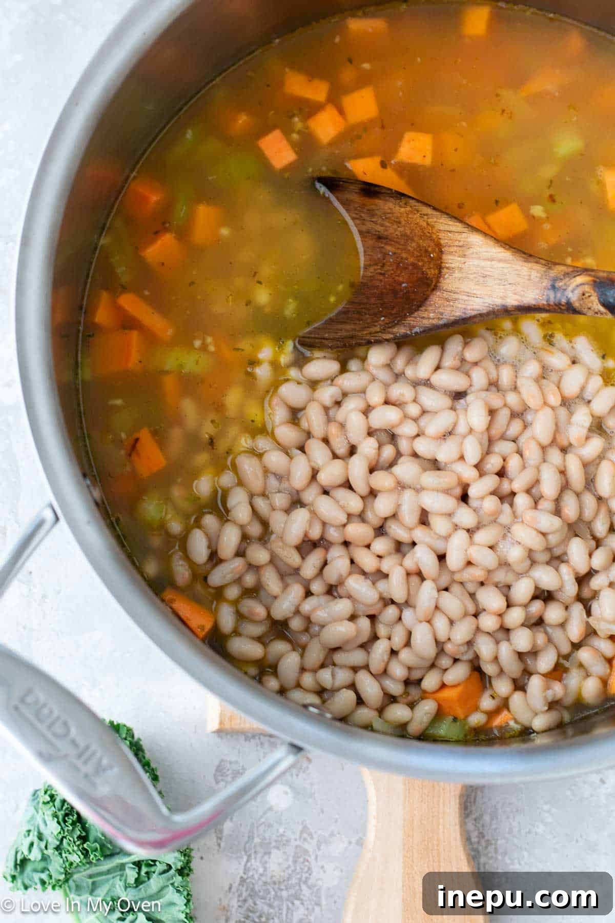 Bowl of sweet potato and white bean soup on a wooden table
