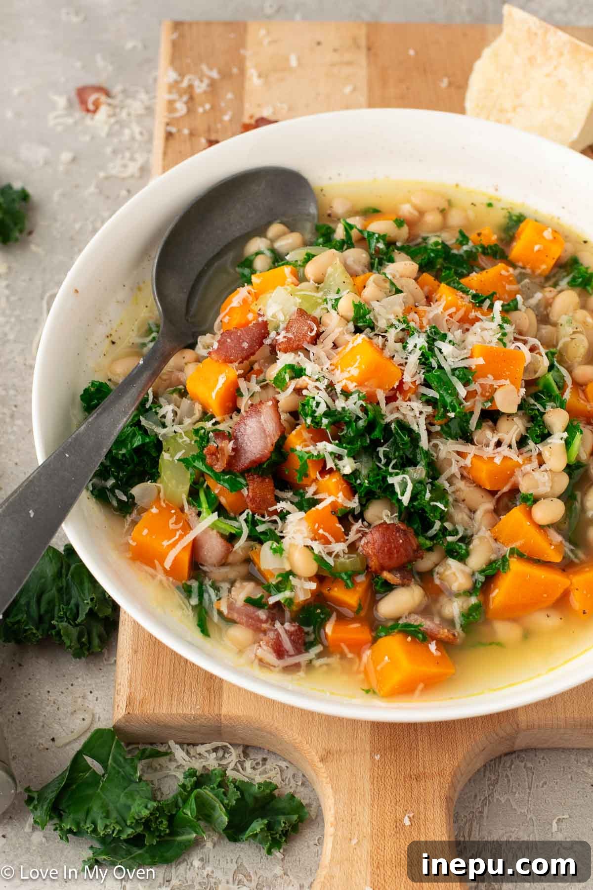 Overhead shot of sweet potato and white bean soup in a rustic bowl