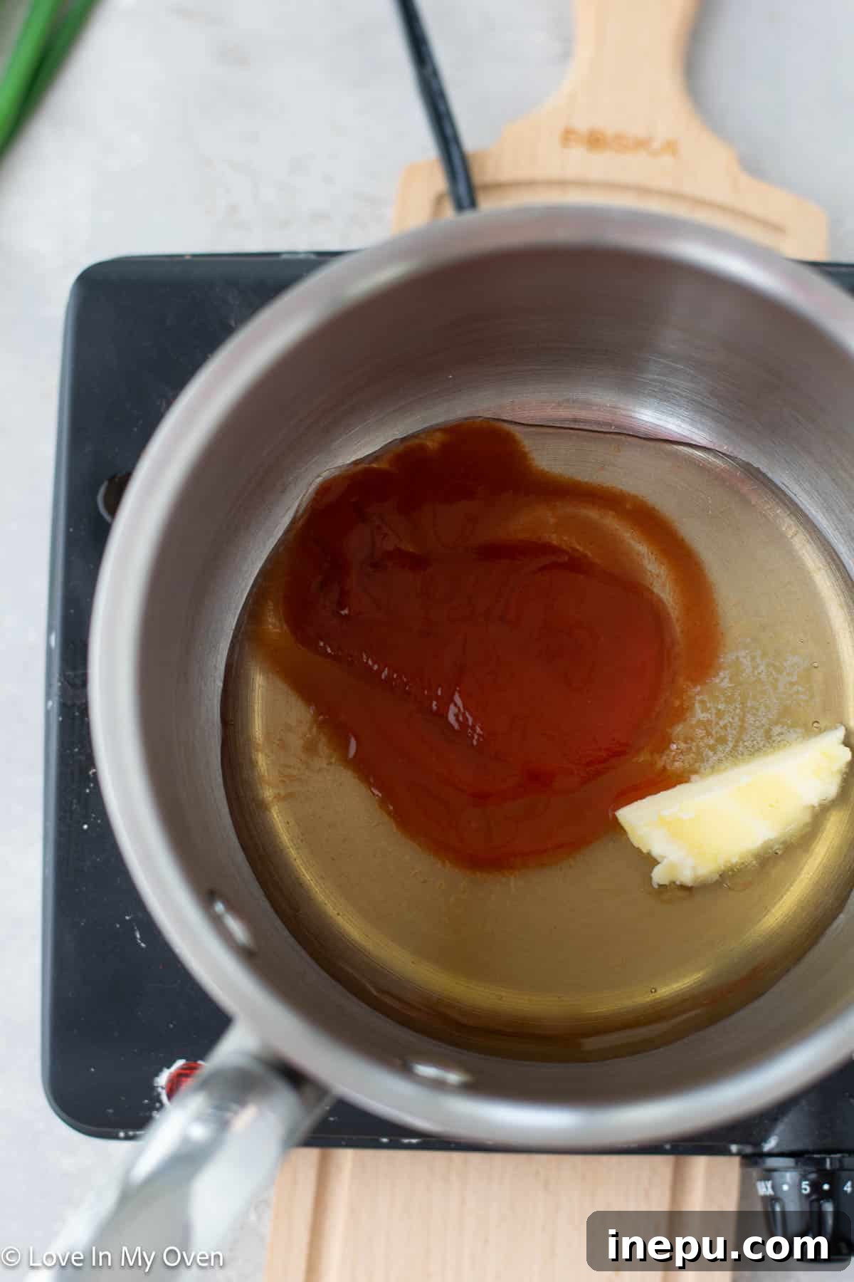 Hot honey sauce simmering in a saucepan
