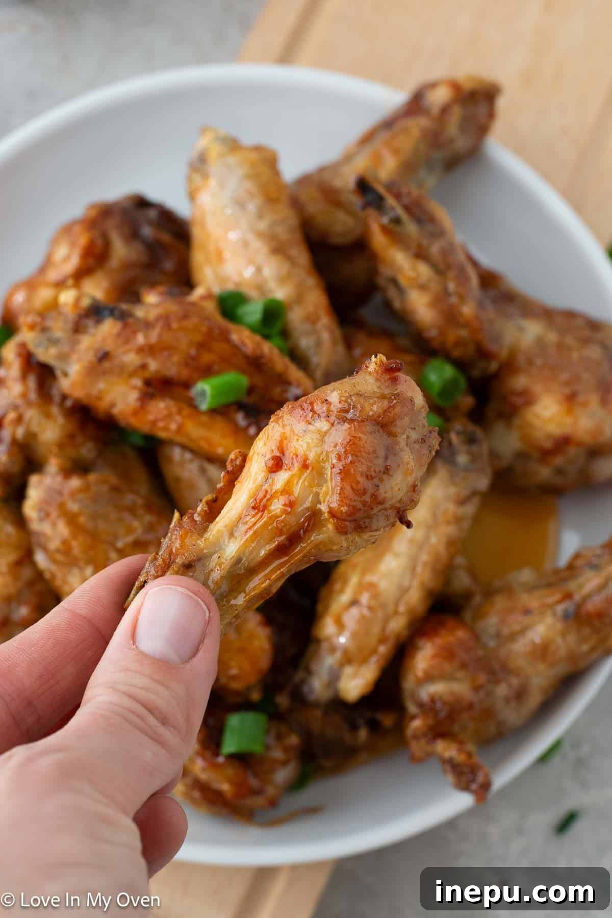 Platter of hot honey chicken wings with a side of ranch dip