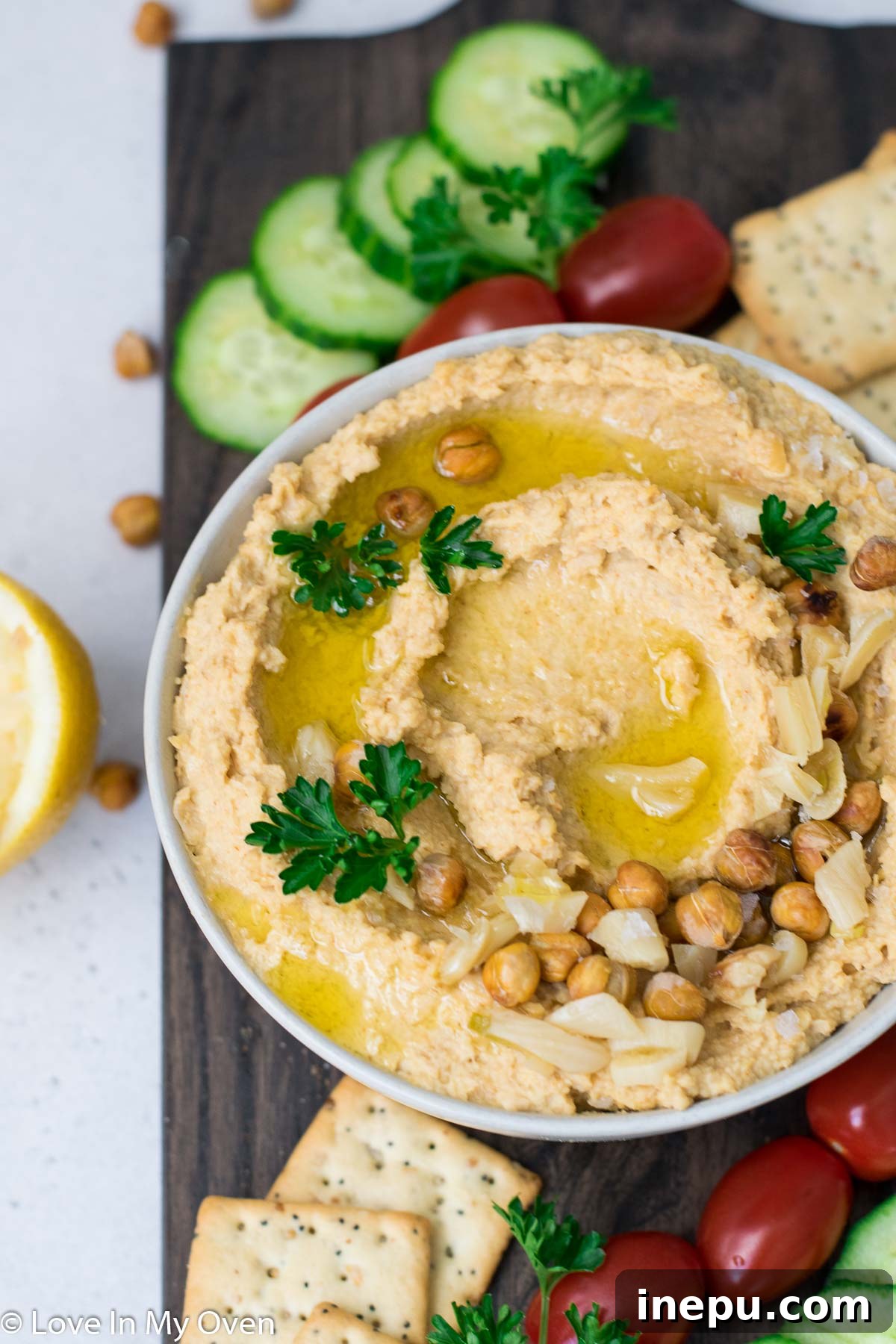 Golden Roasted Garlic Hummus 3 Toddler joyfully eating creamy roasted garlic hummus spread on a cracker