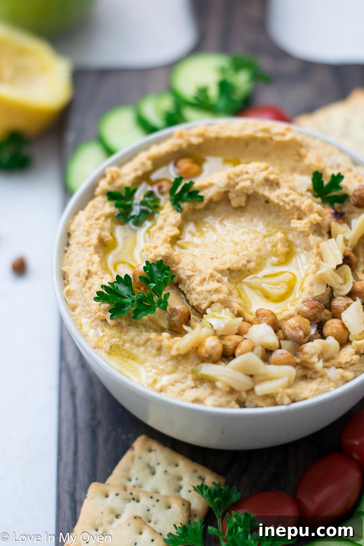 Golden Roasted Garlic Hummus 6 Roasted Garlic Hummus in a serving bowl, garnished with paprika and a drizzle of olive oil