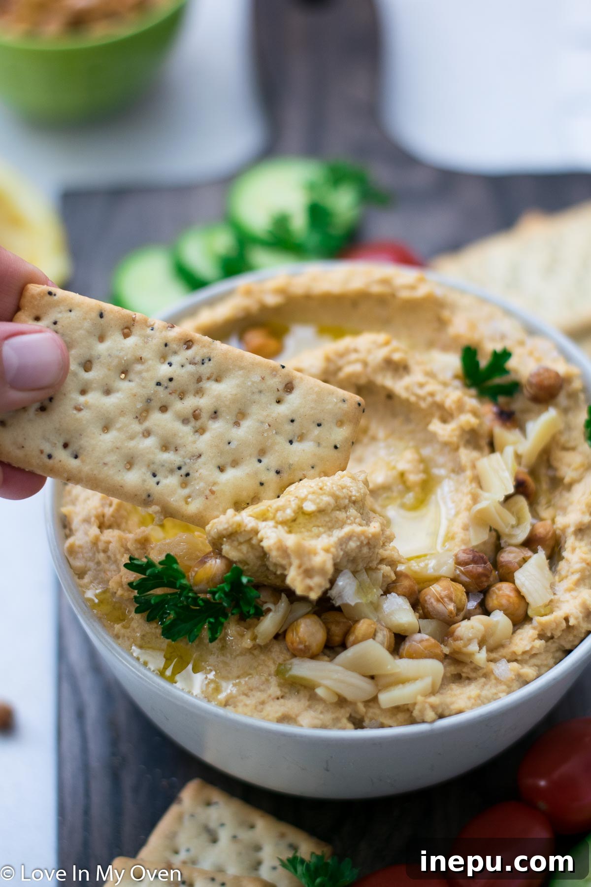 Golden Roasted Garlic Hummus 7 Overhead shot of a platter with Roasted Garlic Hummus, fresh pita bread, and assorted raw vegetables