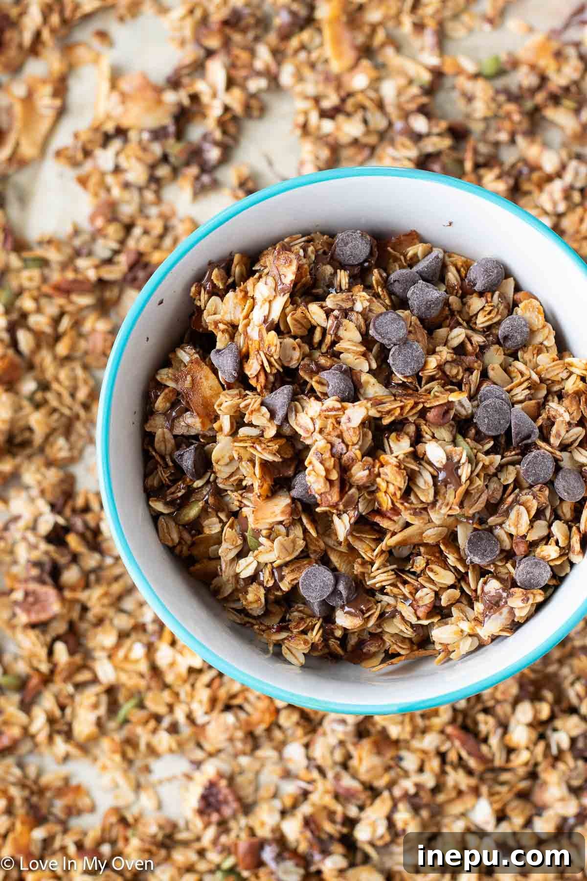 Hand scooping pecan coconut granola