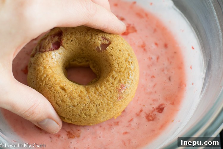 Baked strawberry donuts with glaze setting