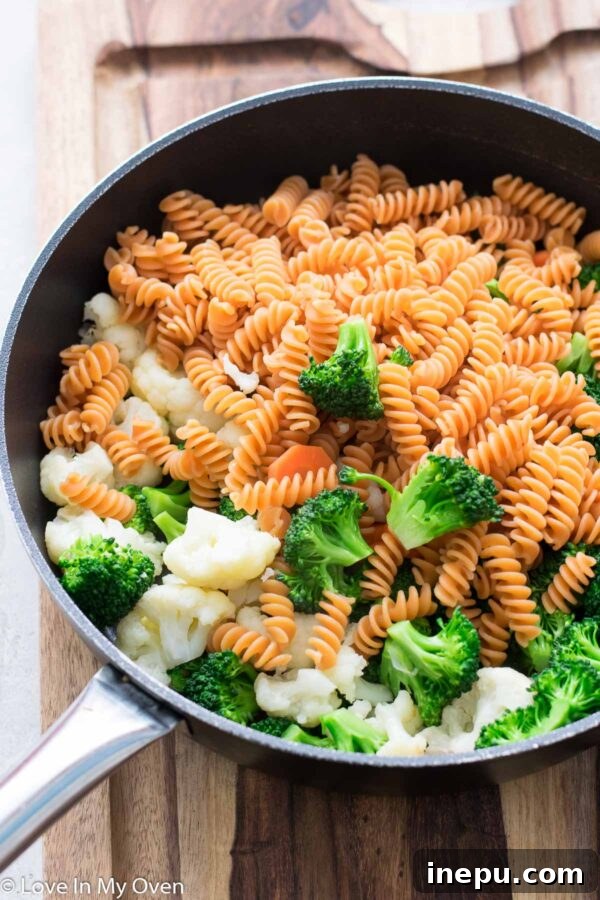 Draining cooked pasta for creamy vegetable casserole
