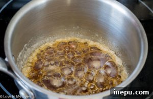 Caramelized sugar mixture reaching a deep amber color in the pan