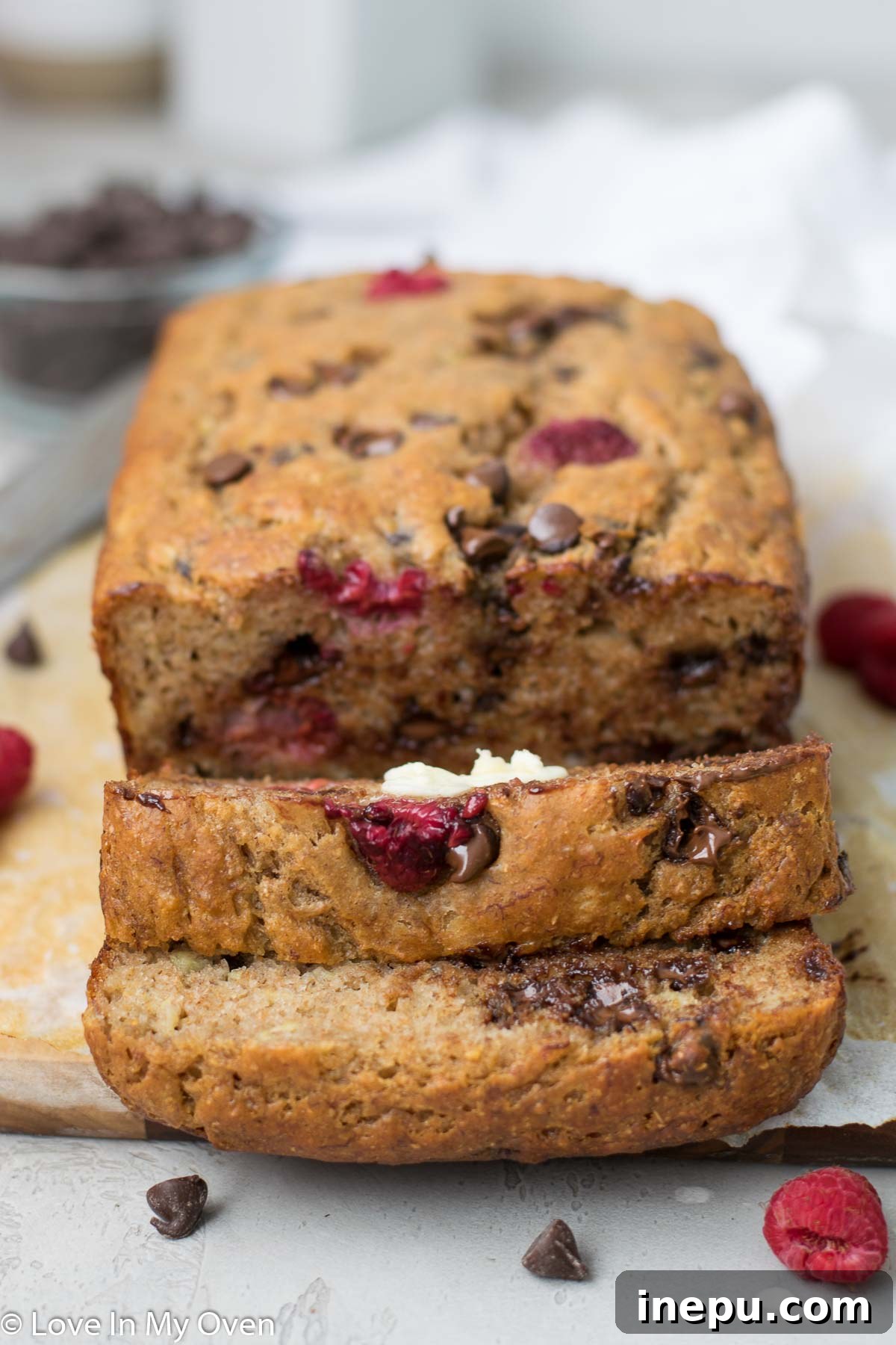 Raspberry banana bread loaf on a cooling rack