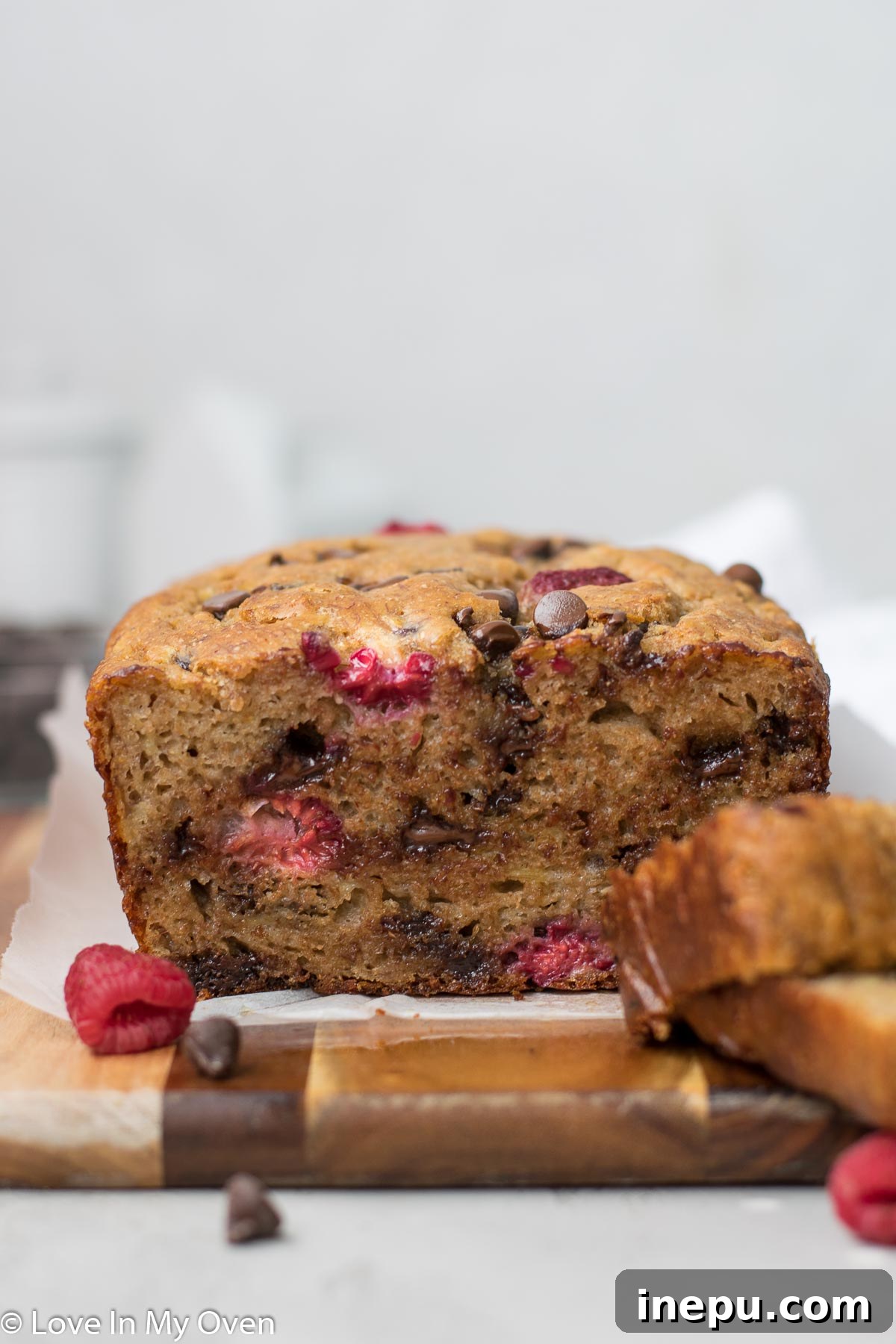 A slice of raspberry banana bread with dark chocolate chips