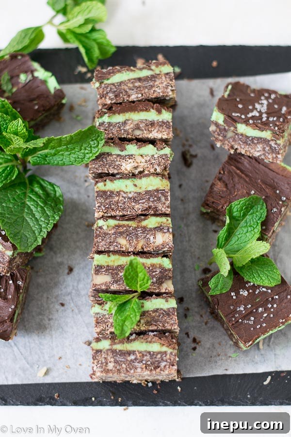 Close-up of freshly baked Mint Nanaimo Bars, showing the three distinct layers