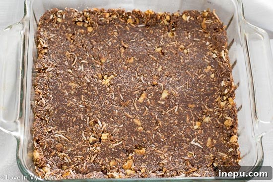 Preparation of the bottom layer for Nanaimo bars in a square baking pan