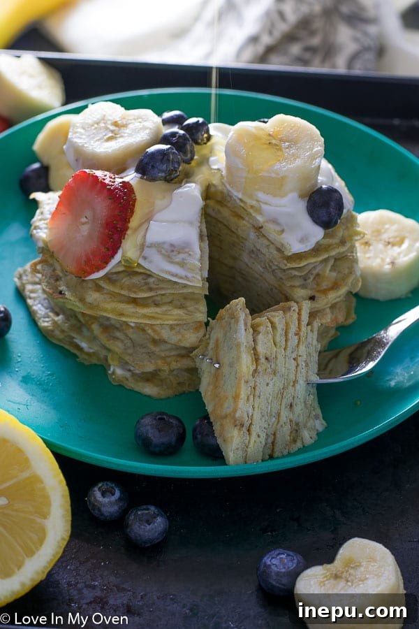 Dynamic Duo Flapjacks 9 baby and me pancakes on a plate with fresh berries.