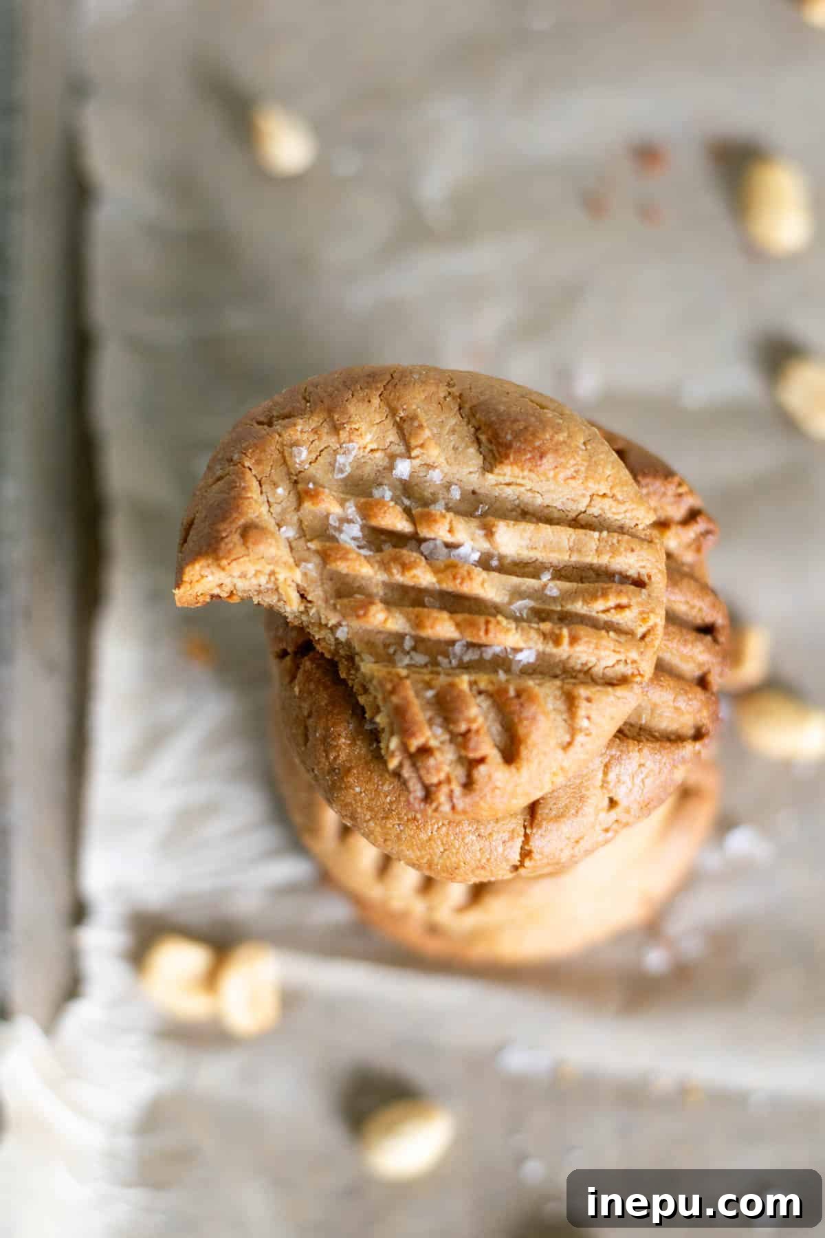 Multiple 3-ingredient gluten-free peanut butter cookies stacked on a plate